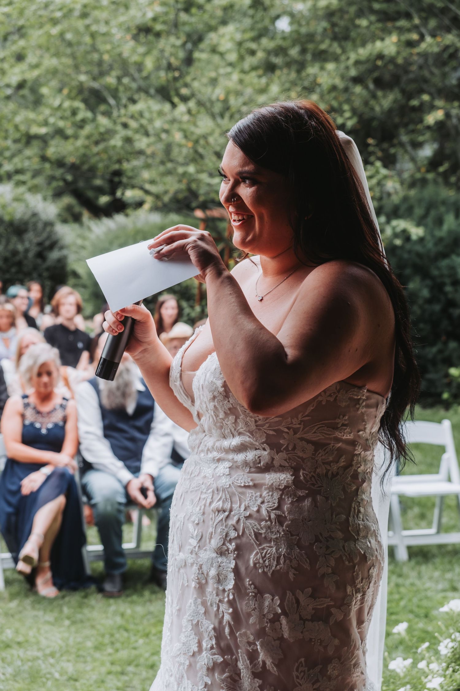Wedding celebration in a garden with guests enjoying festivities and dancing.