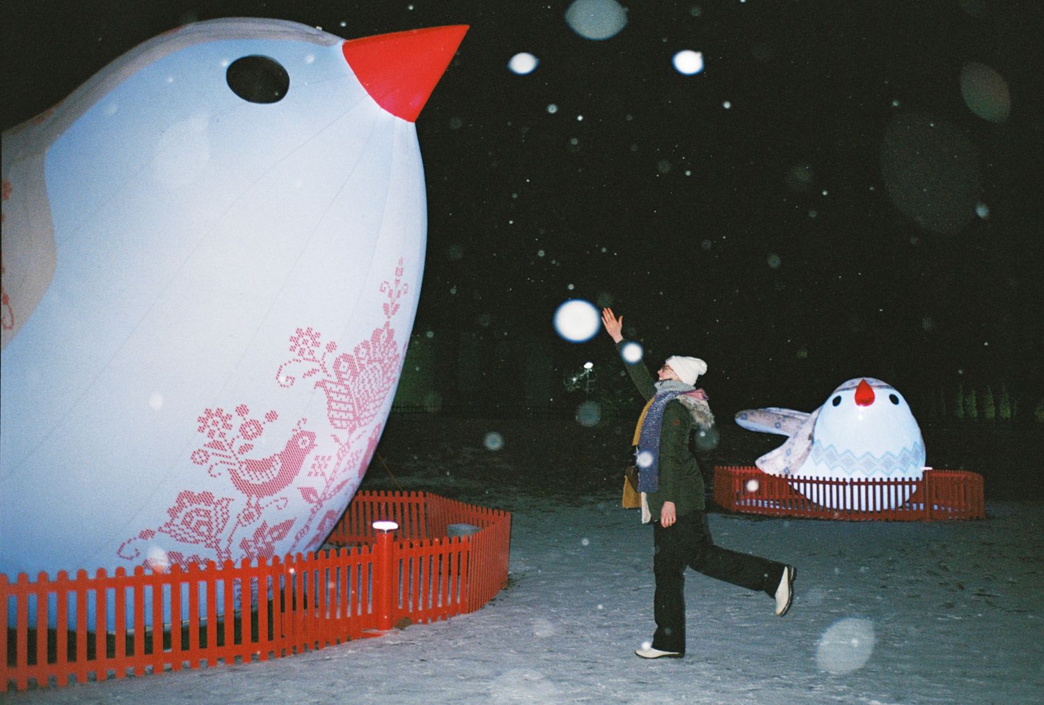 Red and white inflatable objects arranged against a dark background in a panoramic sequence.