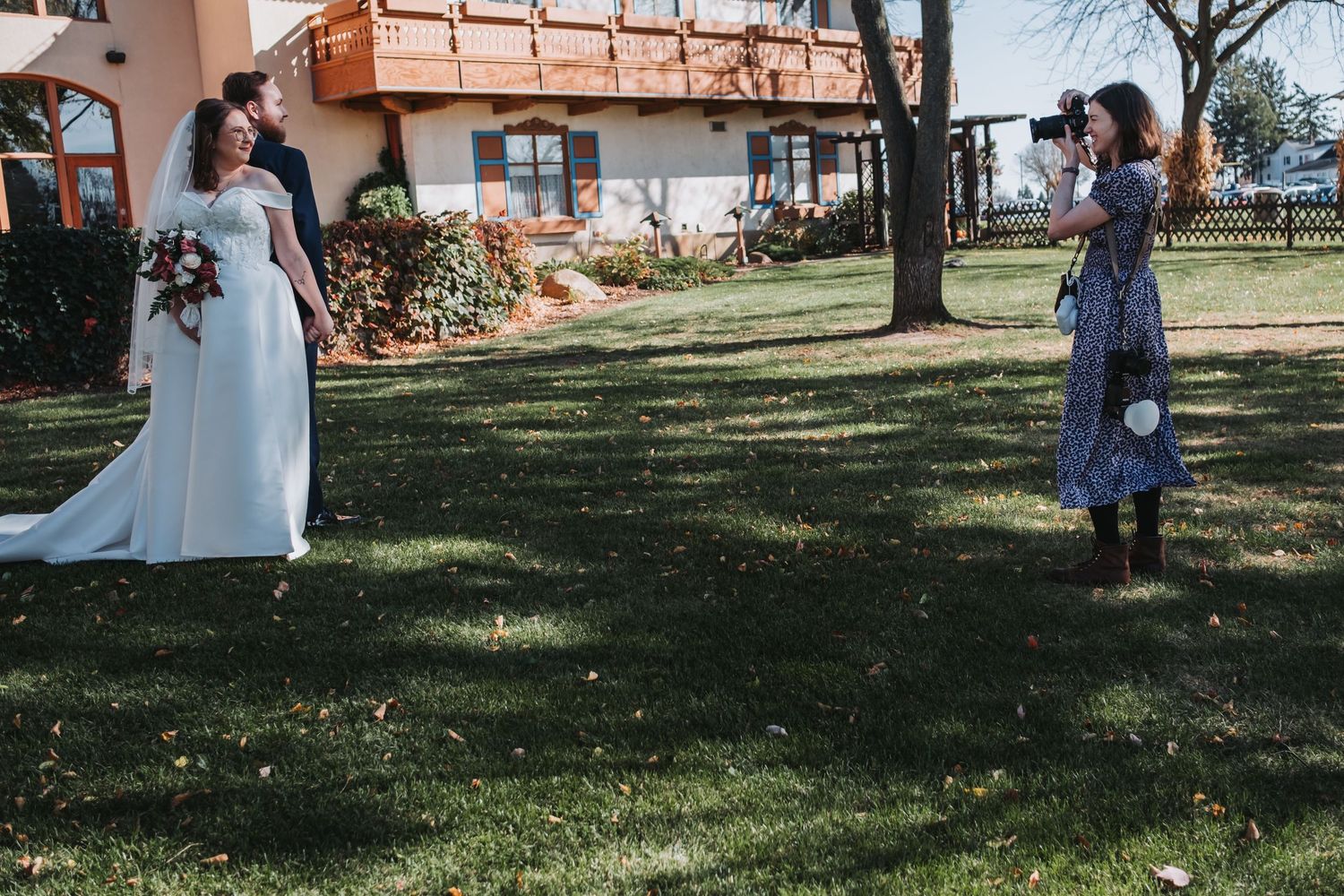 Outdoor wedding photography session in a sunny garden setting.