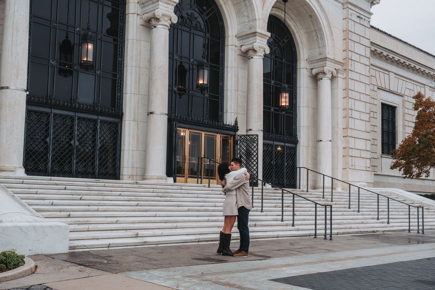 Classical architecture with white stone columns and arched windows on a grand building facade.