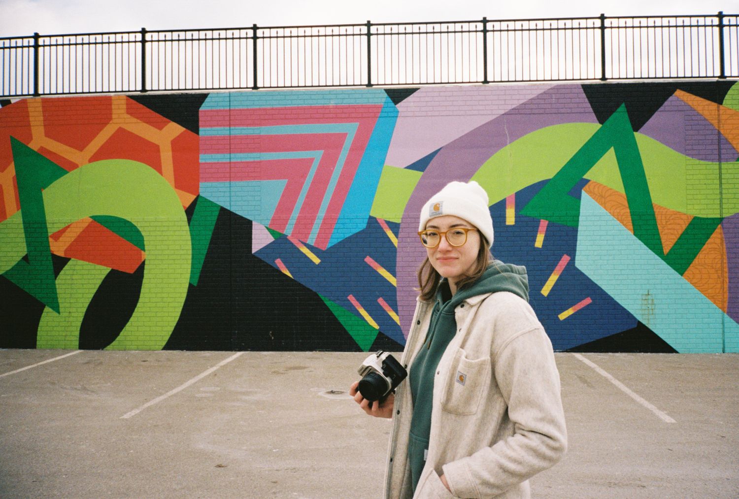 Colorful geometric mural with abstract shapes and patterns on outdoor wall.