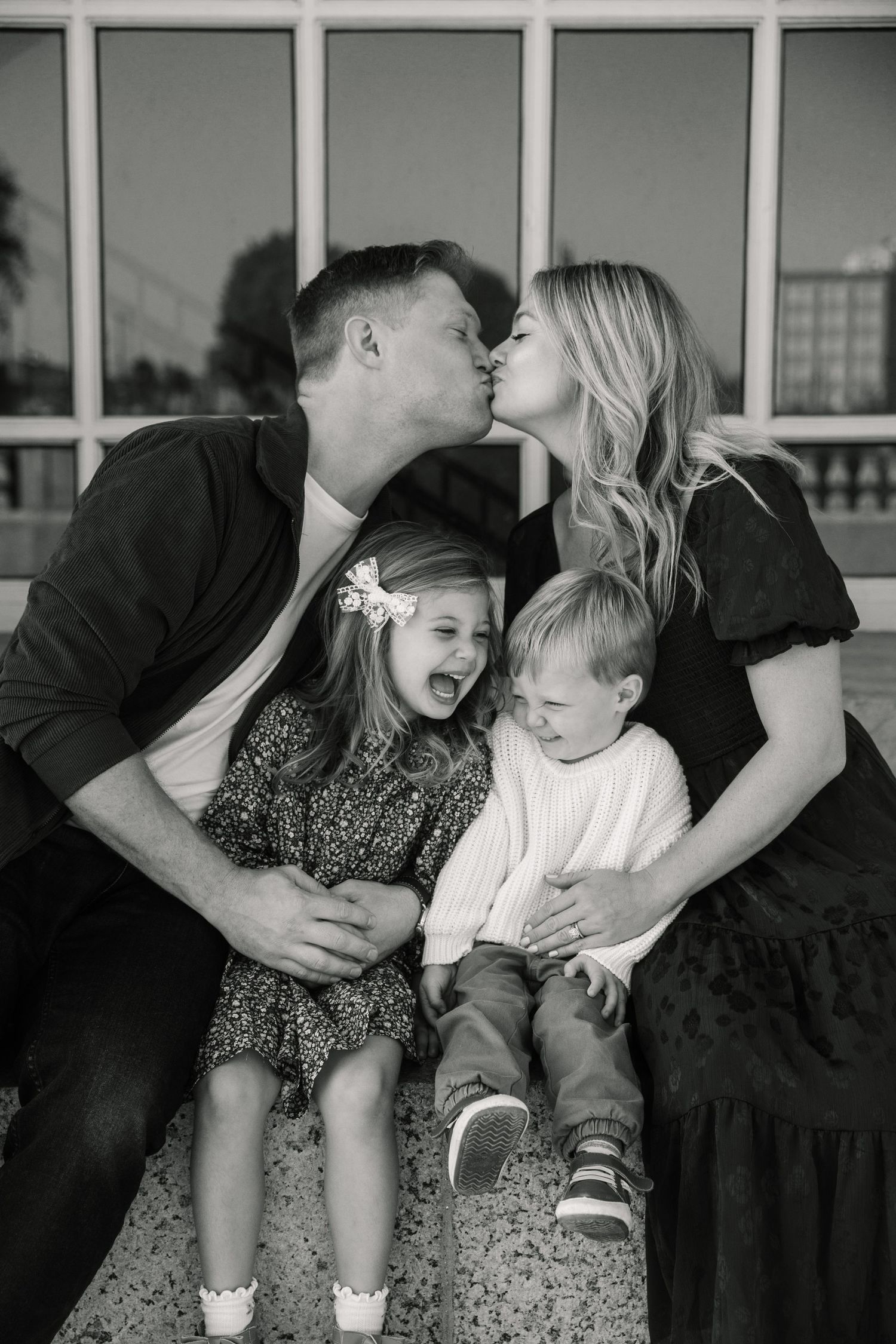 Black and white family portrait showing joyful moments and laughter.