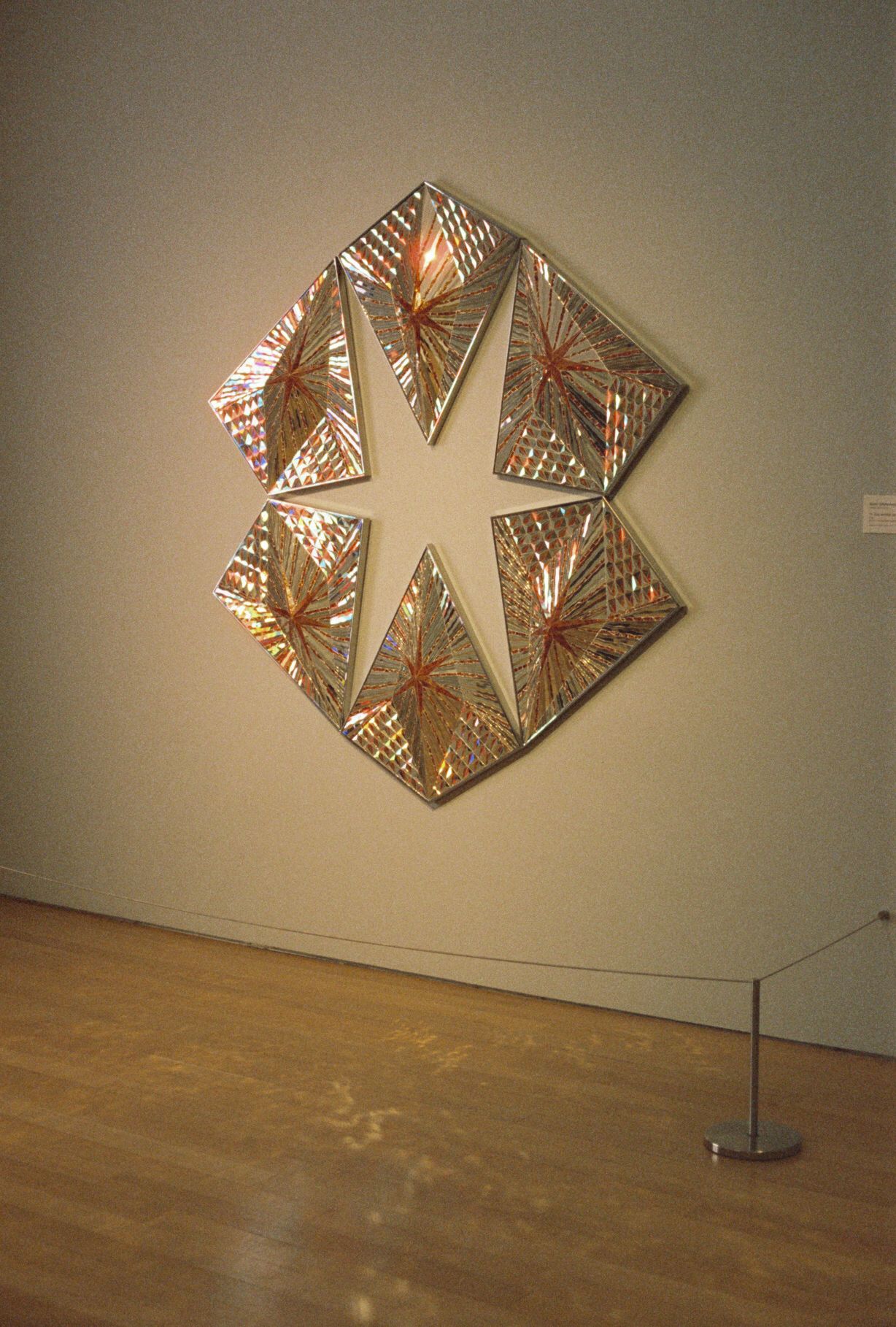 Modern geometric copper wall art installation in minimalist gallery space.