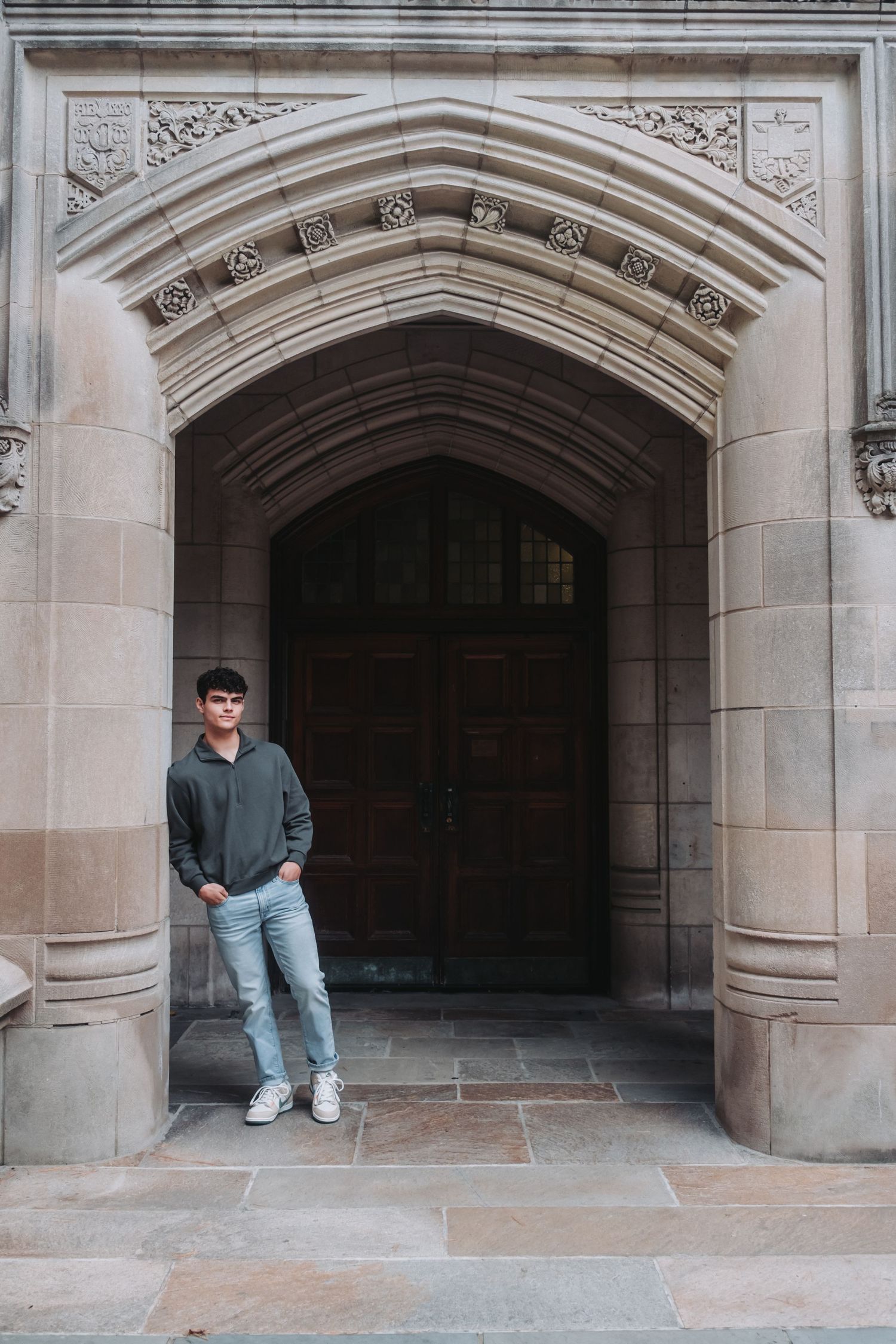 Gothic stone archways in a historic building with decorative carved details.