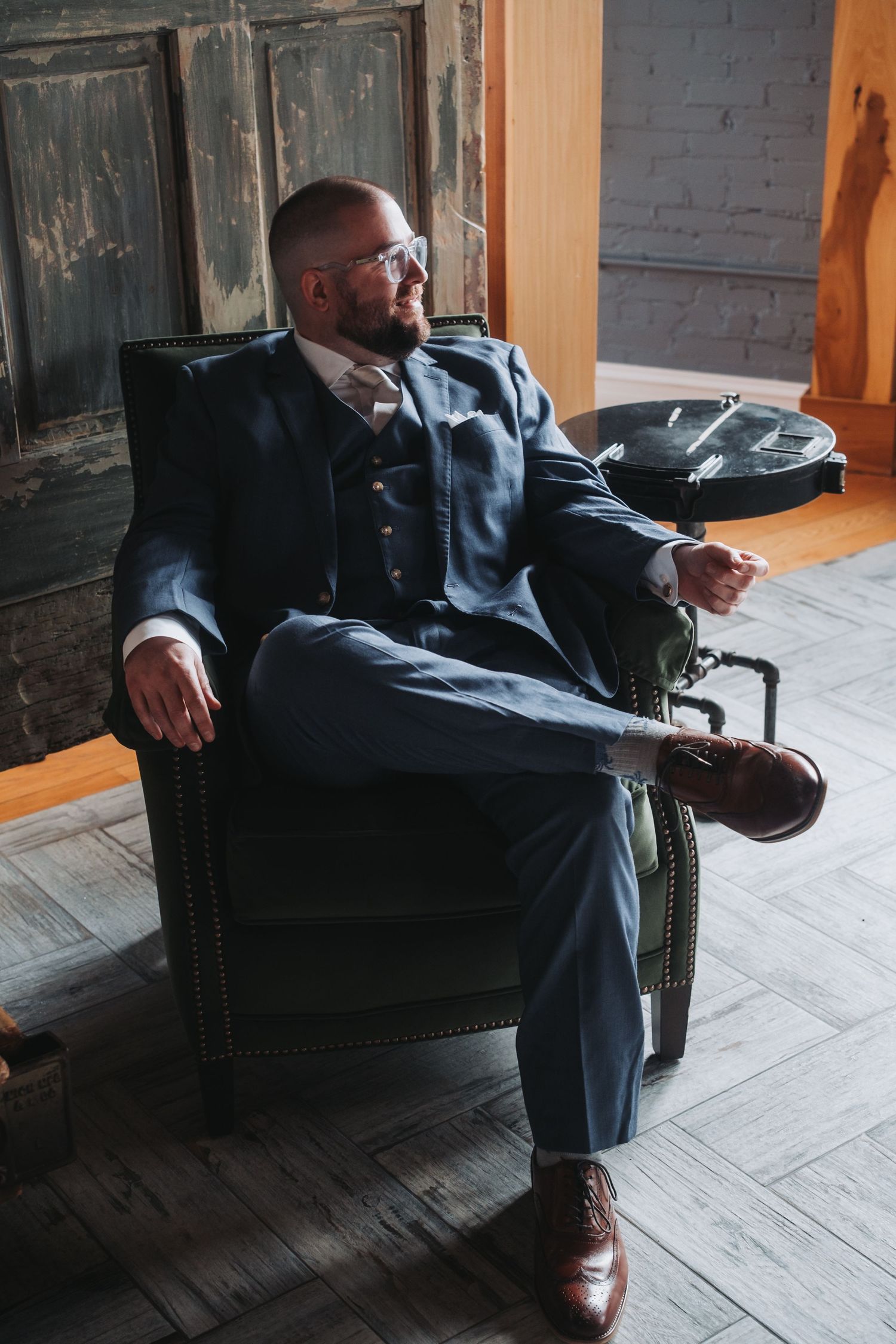 Elegant formal attire captured in a rustic setting with wooden floors and industrial details.