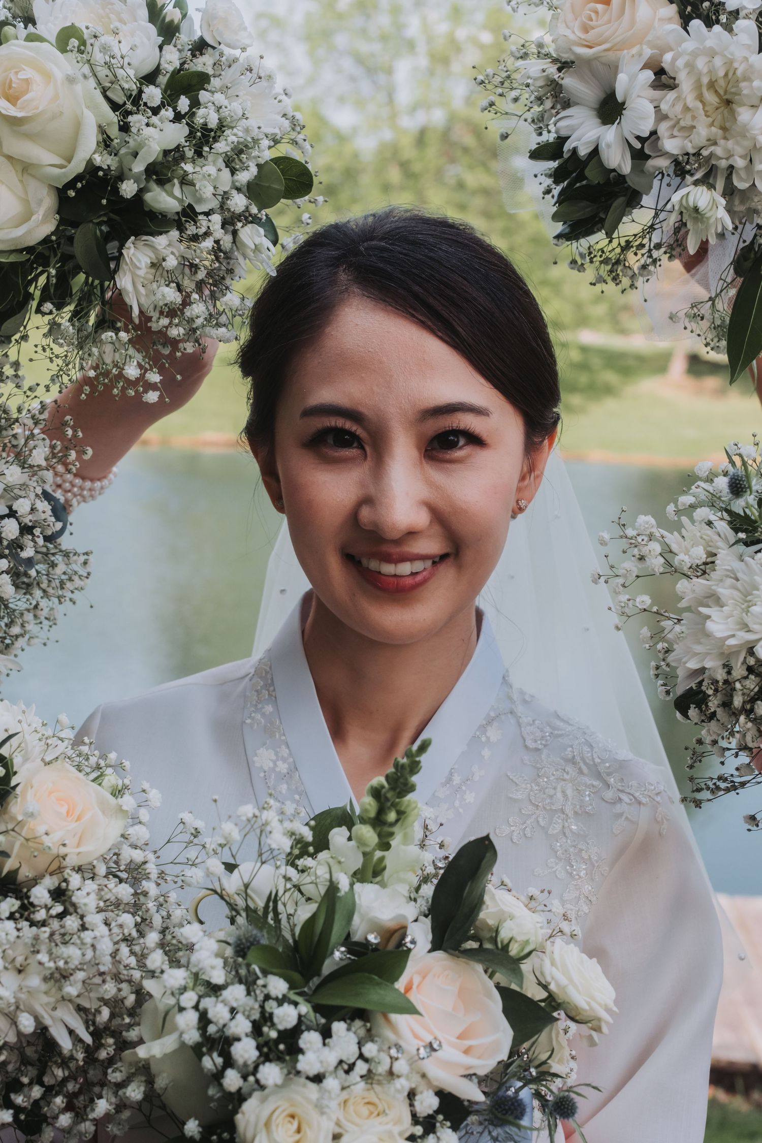 Close-up of a bridal bouquet with white roses and baby's breath flowers.