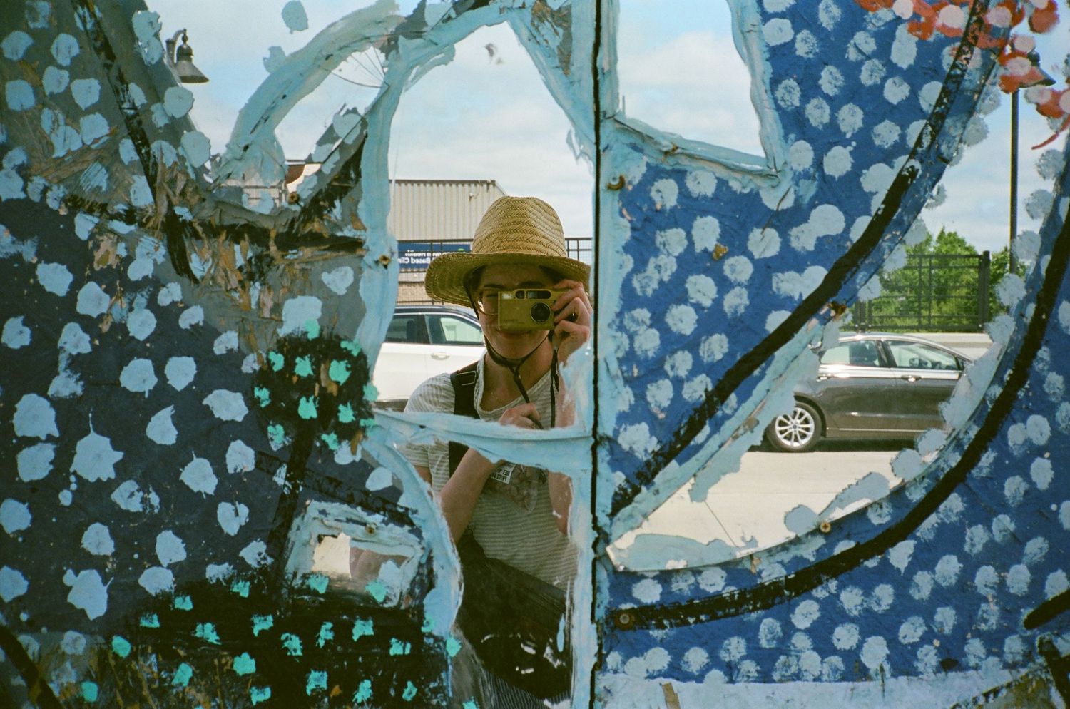 Vintage car reflected in multiple overlapping mirror fragments with blue tint.
