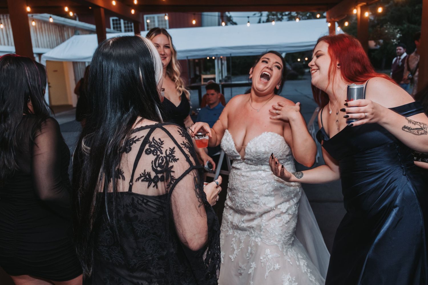 Wedding reception party scene with dancing and celebrations in dimly lit venue.