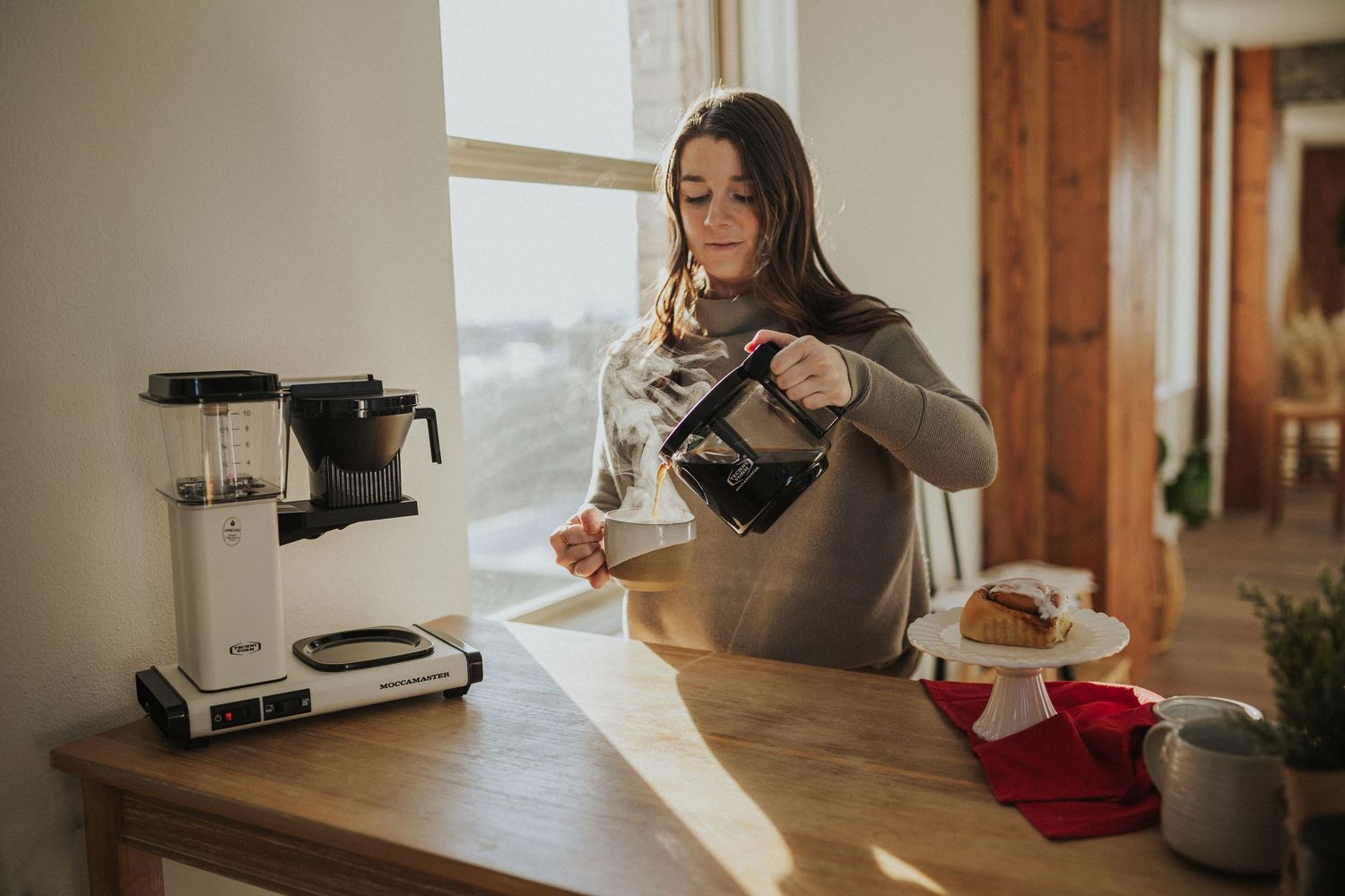 Modern coffee brewing setup with pour-over equipment by bright window.