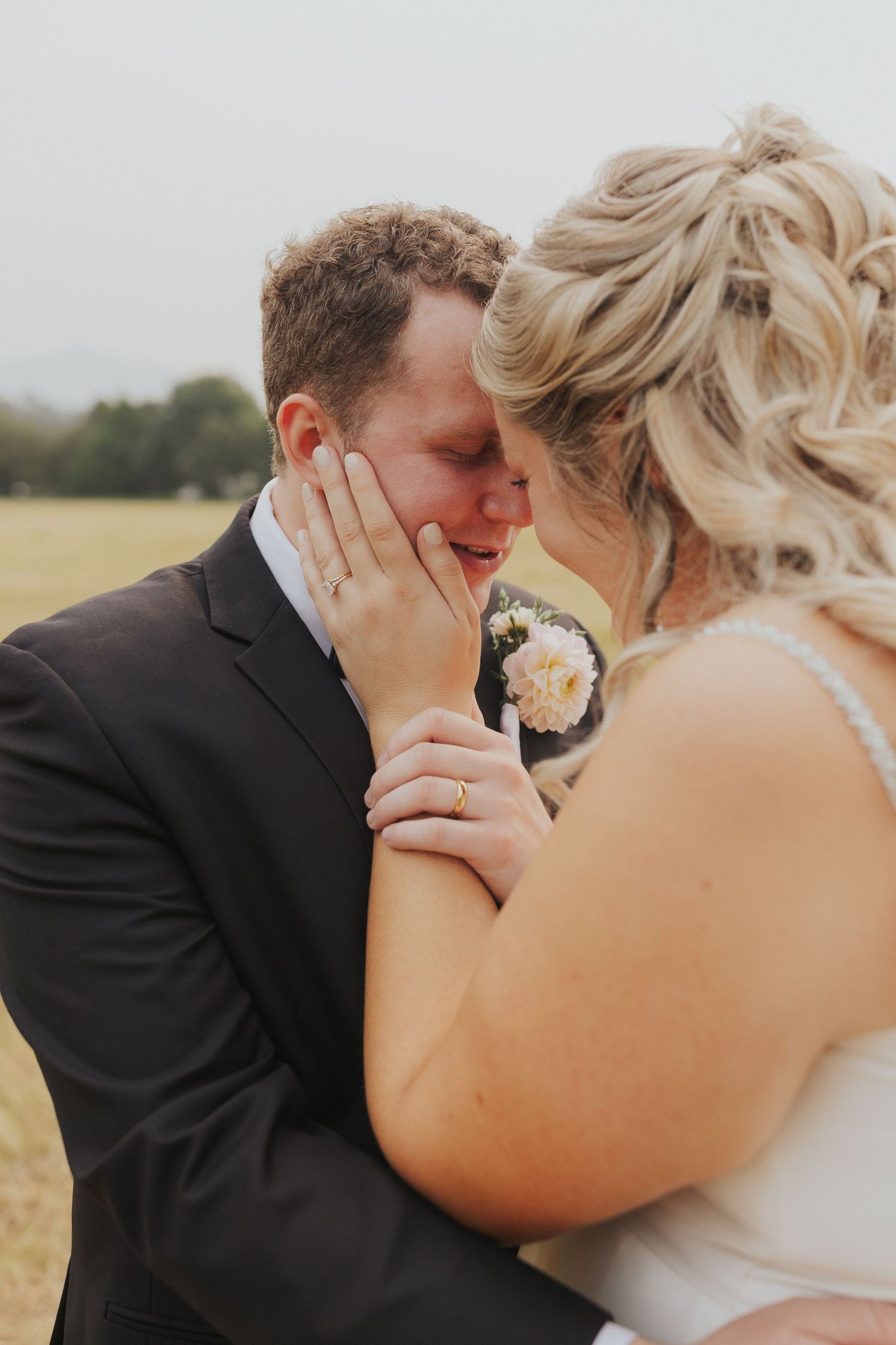 An intimate wedding moment shared between a couple during their outdoor photo session.