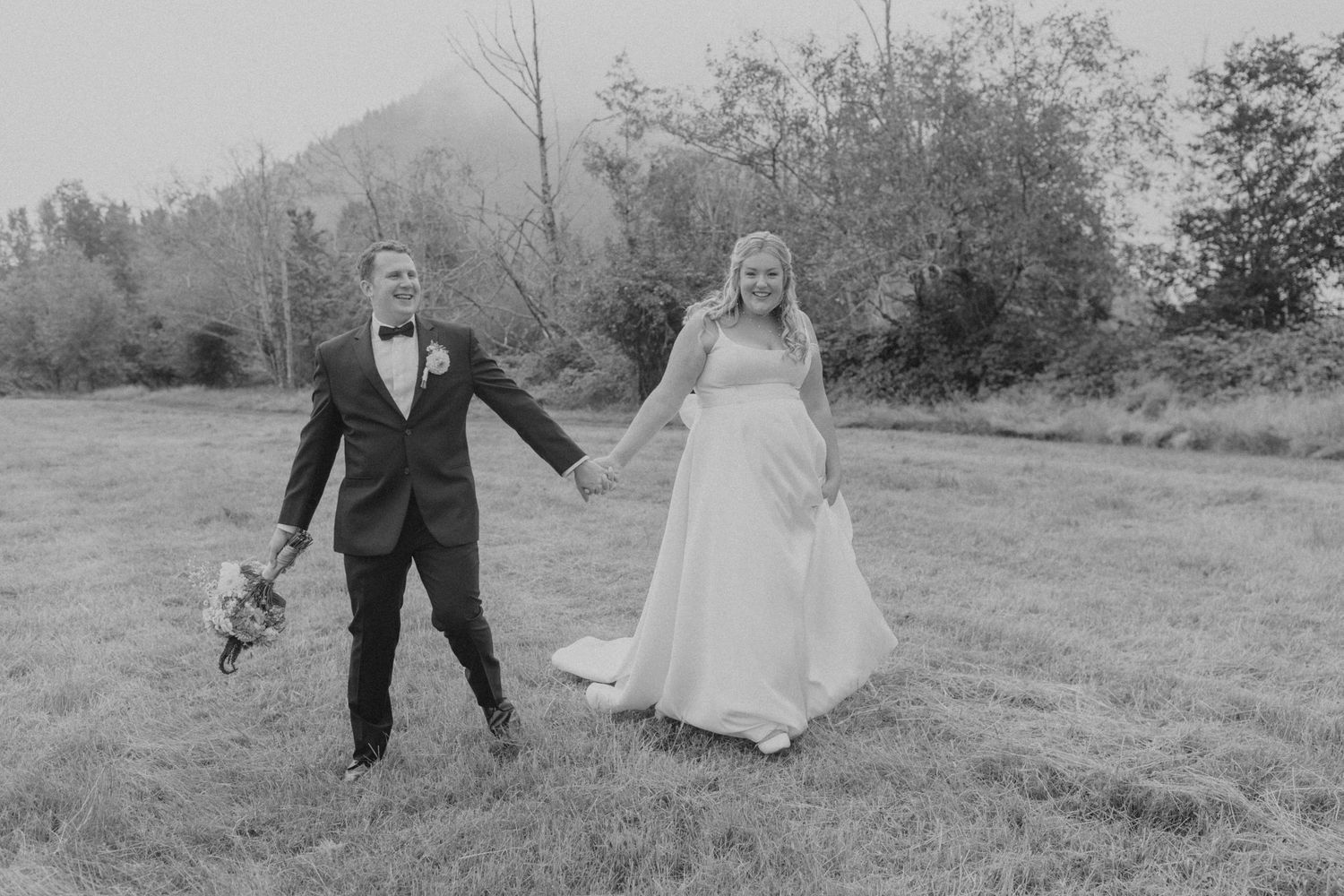 A wedding couple shares candid moments in a rustic outdoor setting.
