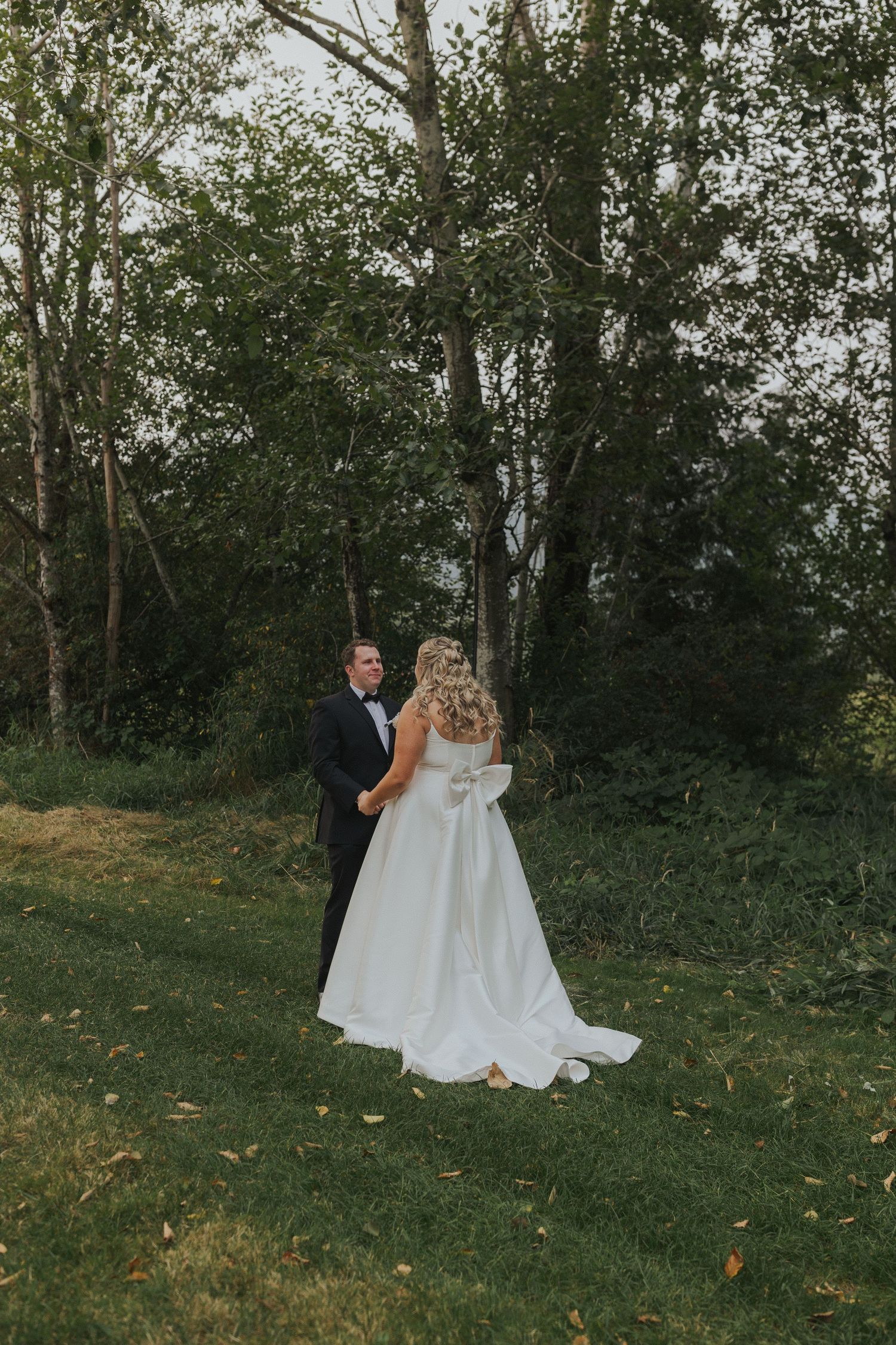 Wedding couple walking through a wooded area on their special day.