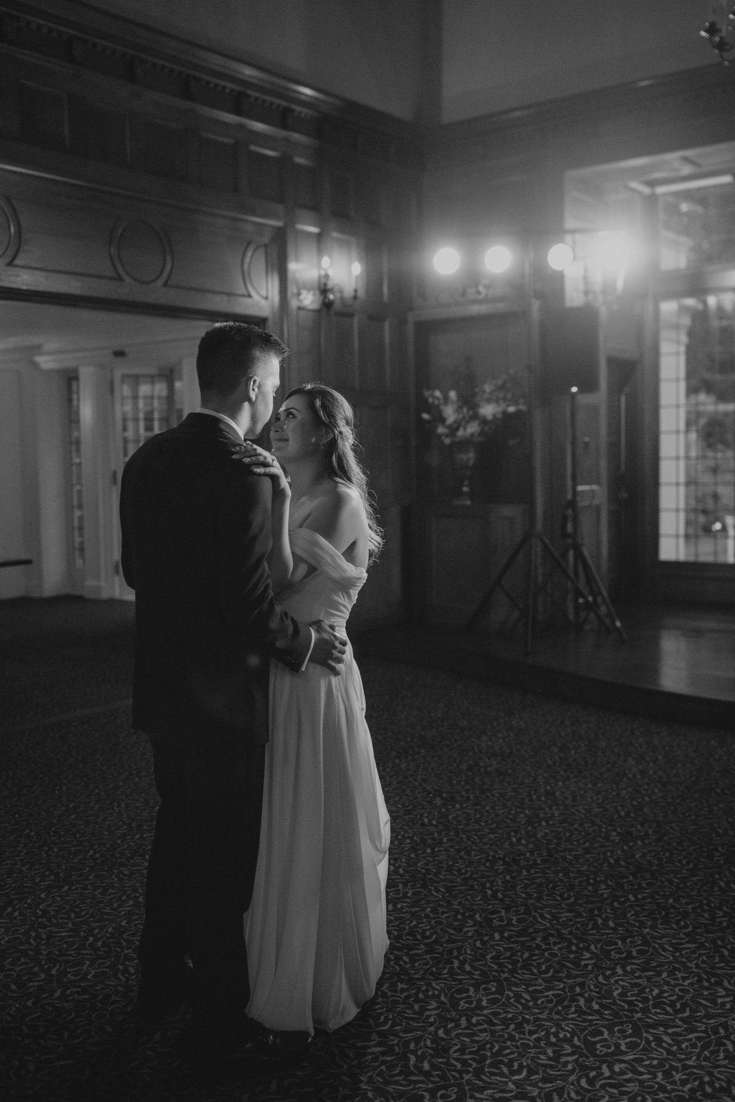 Intimate dance captured in black and white on an elegant ballroom floor.