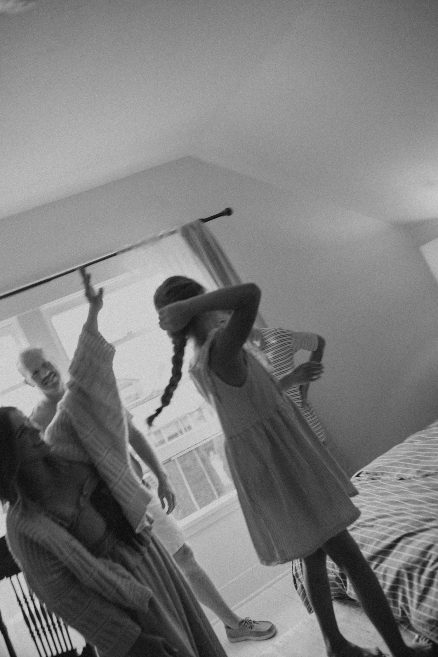Black and white images showing dynamic movement and dancing indoors.