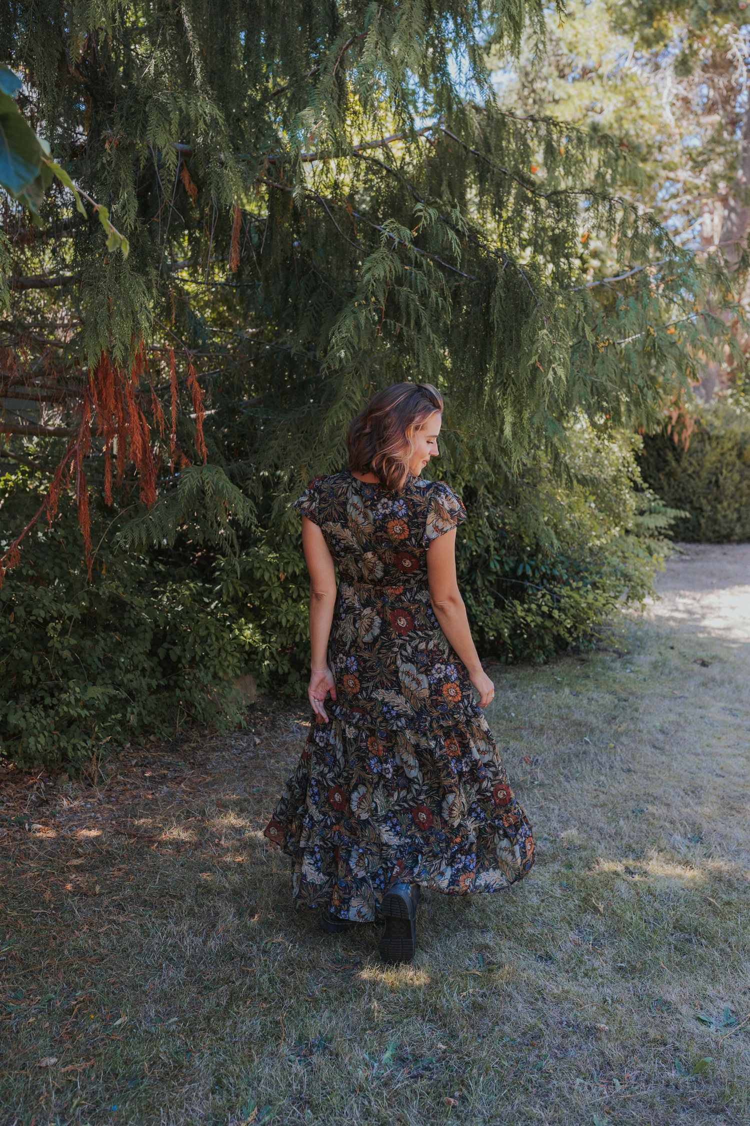 A floral dress twirling sequence photographed in a garden setting.