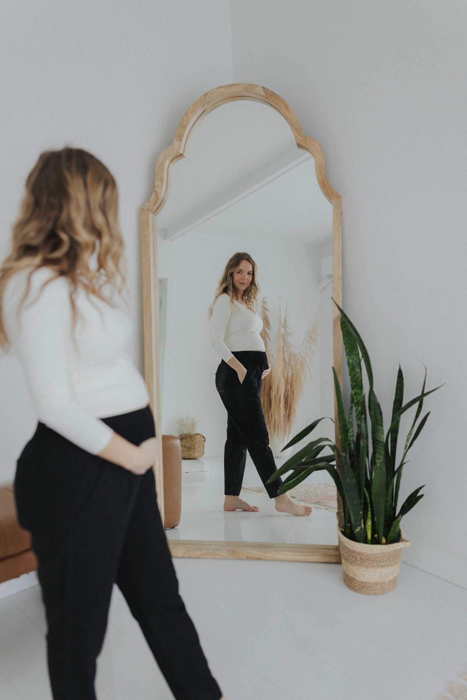 Series of dance movements captured in front of decorative mirror with plant.