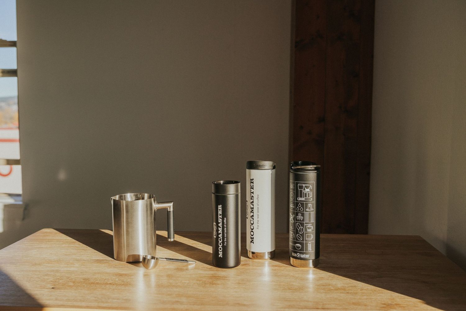 Kitchen counter with minimalist decor and storage containers arranged neatly on wooden surface.