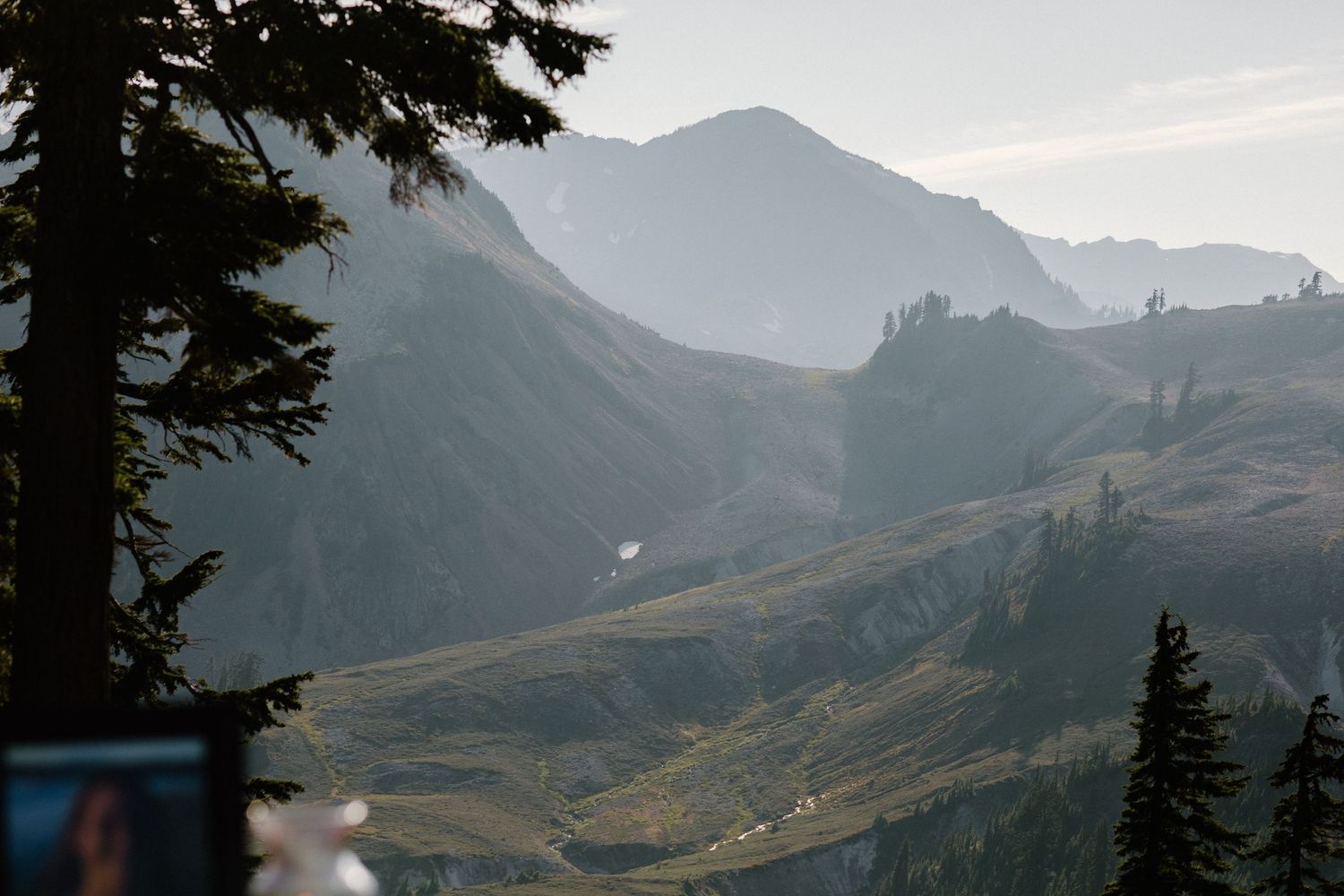 Majestic mountain peaks create a dramatic backdrop for an outdoor wedding ceremony.