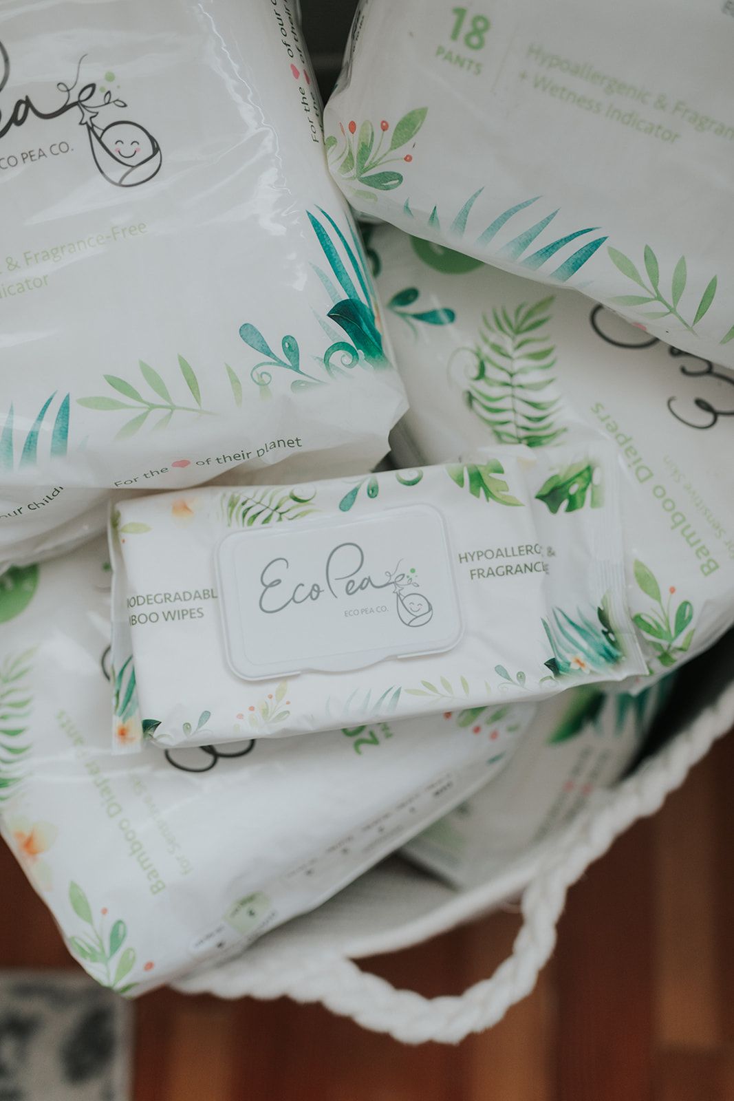 Close-up of eco-friendly diaper packaging with green leaf designs.
