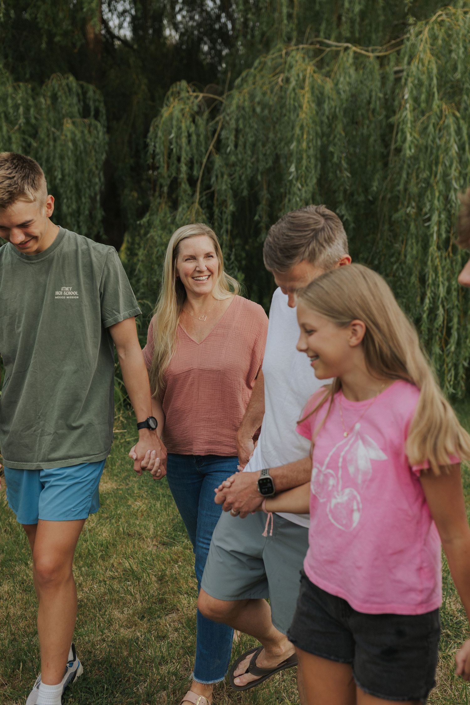 Candid group shots showing laughter and joy under willow trees.