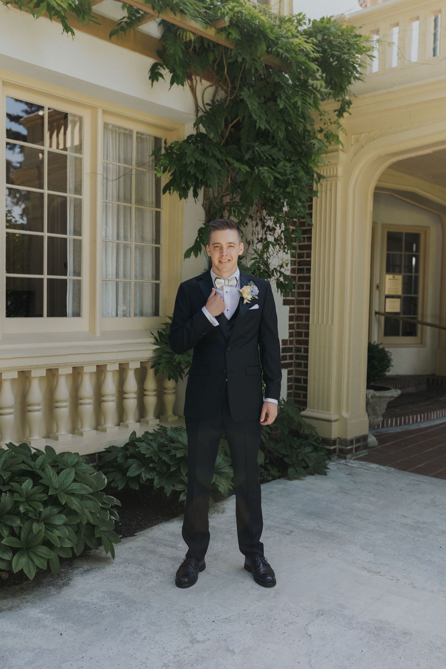 Wedding venue exterior with cream colored walls and architectural columns.