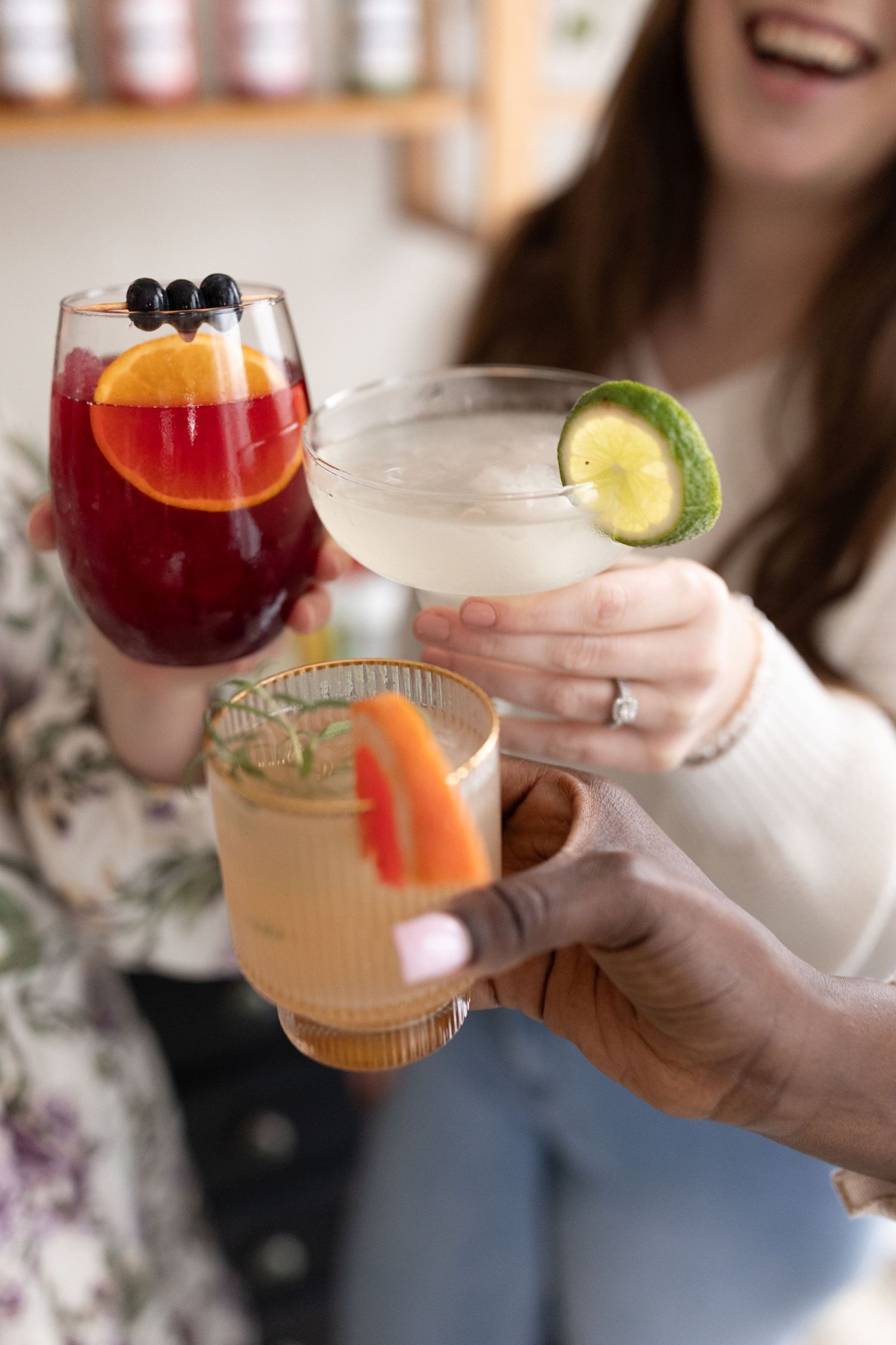 Colorful craft cocktails garnished with citrus and berries.