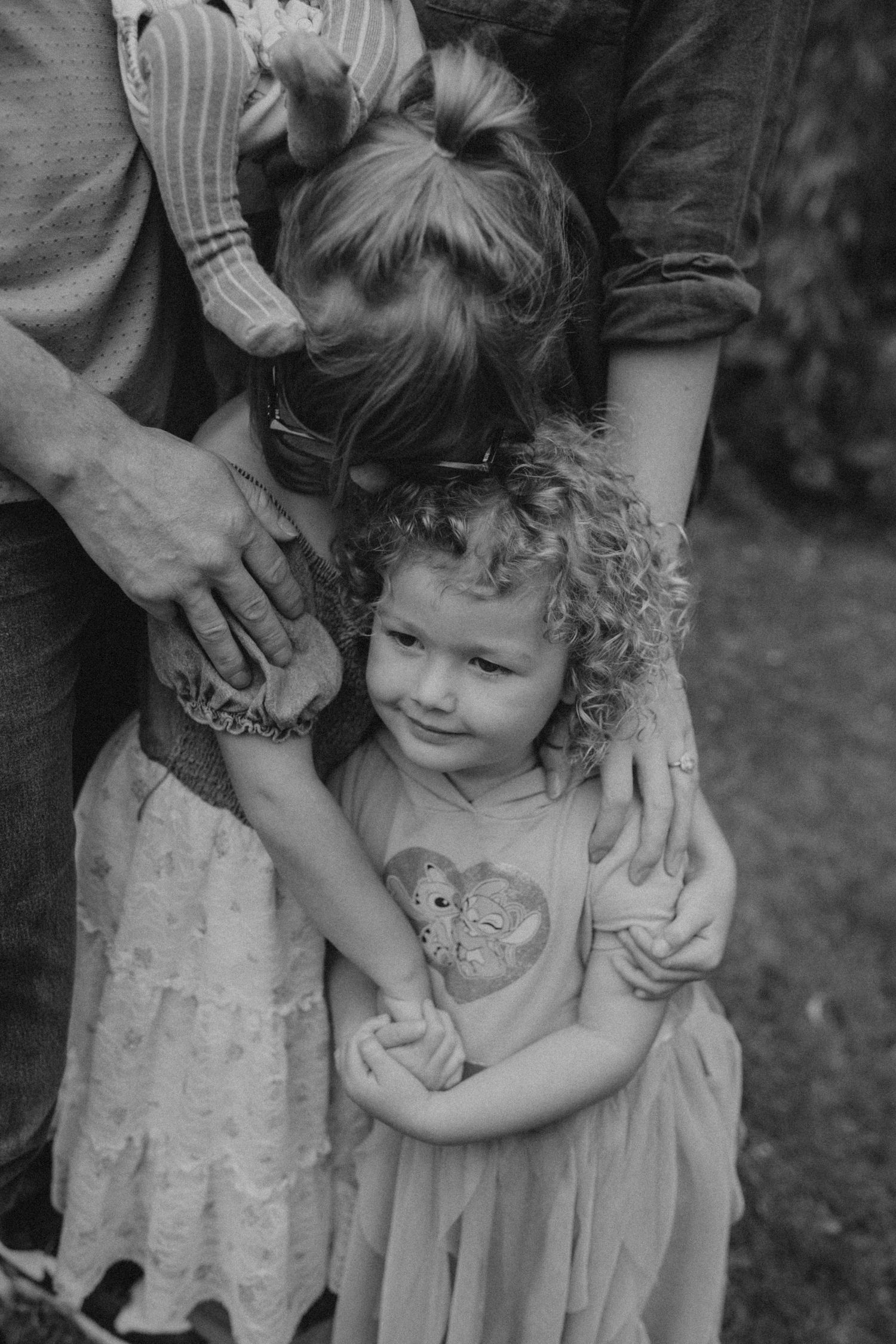 Black and white portrait showing tender family moment with small child.