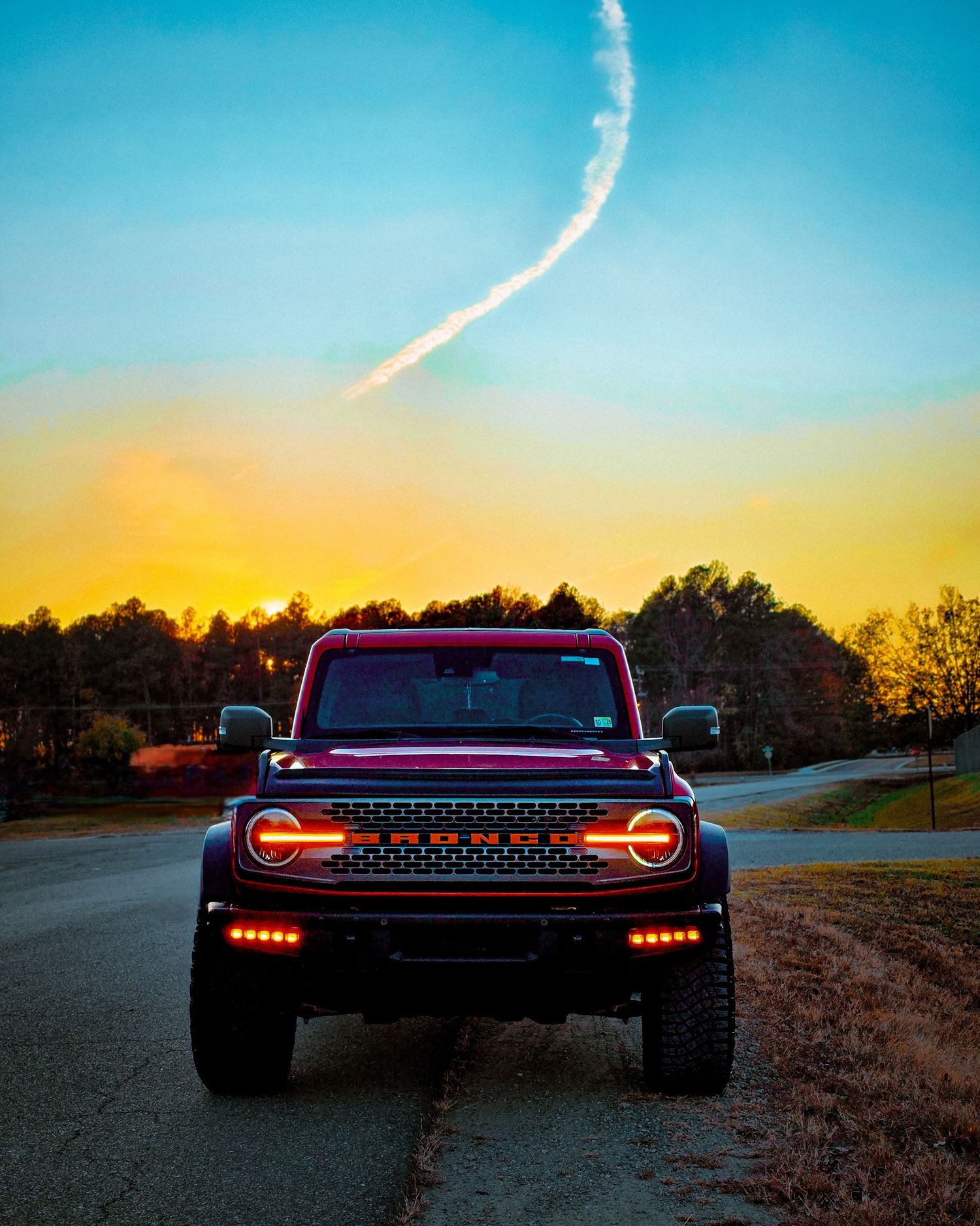 Modern truck with illuminated LED grille and headlights captured at dusk.