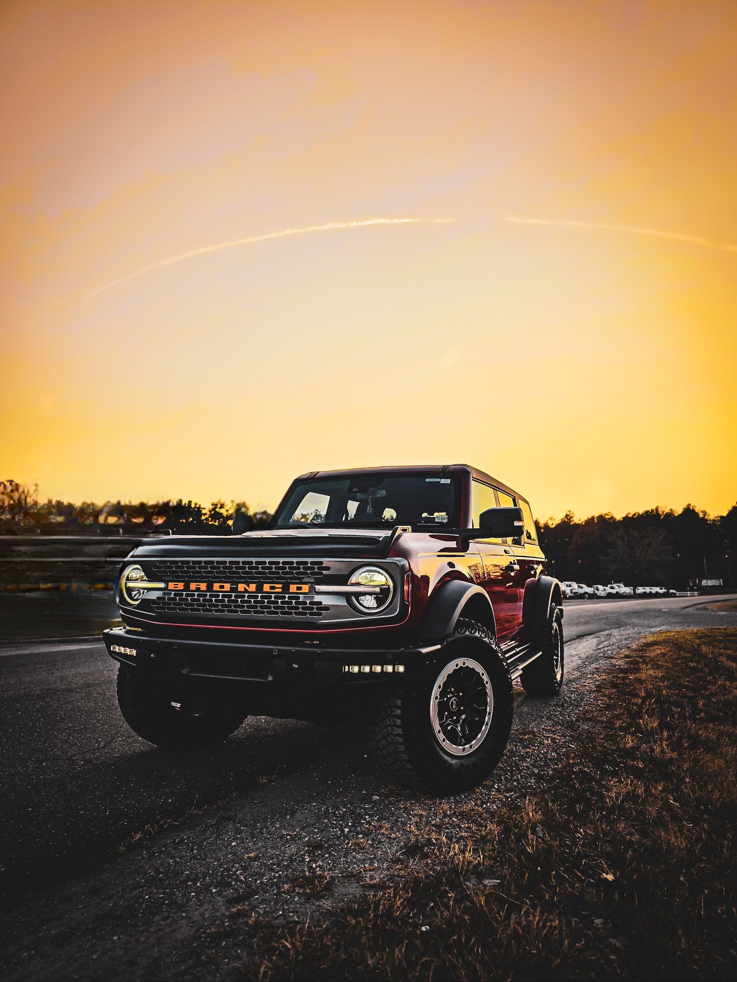 Custom black vehicle with distinctive LED lighting photographed at golden hour.