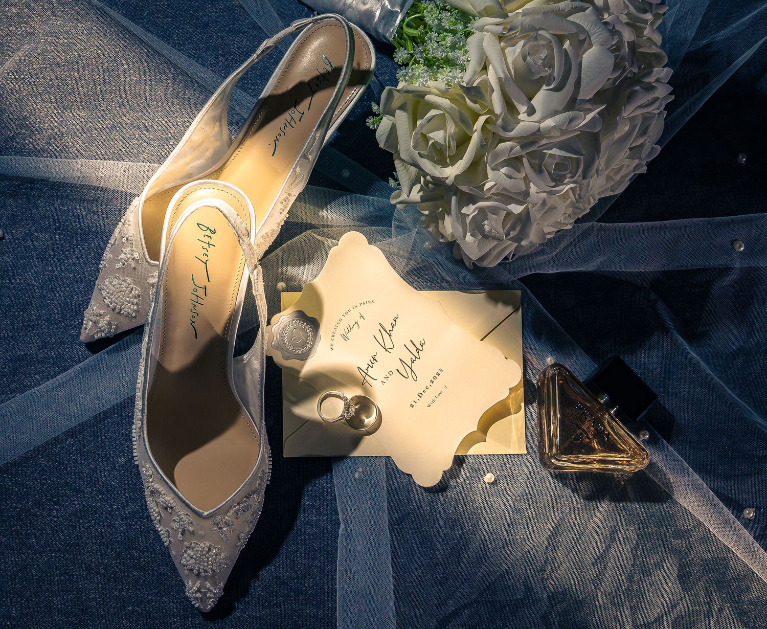A series of elegant silver high heel shoes arranged in a row with romantic floral decorations.