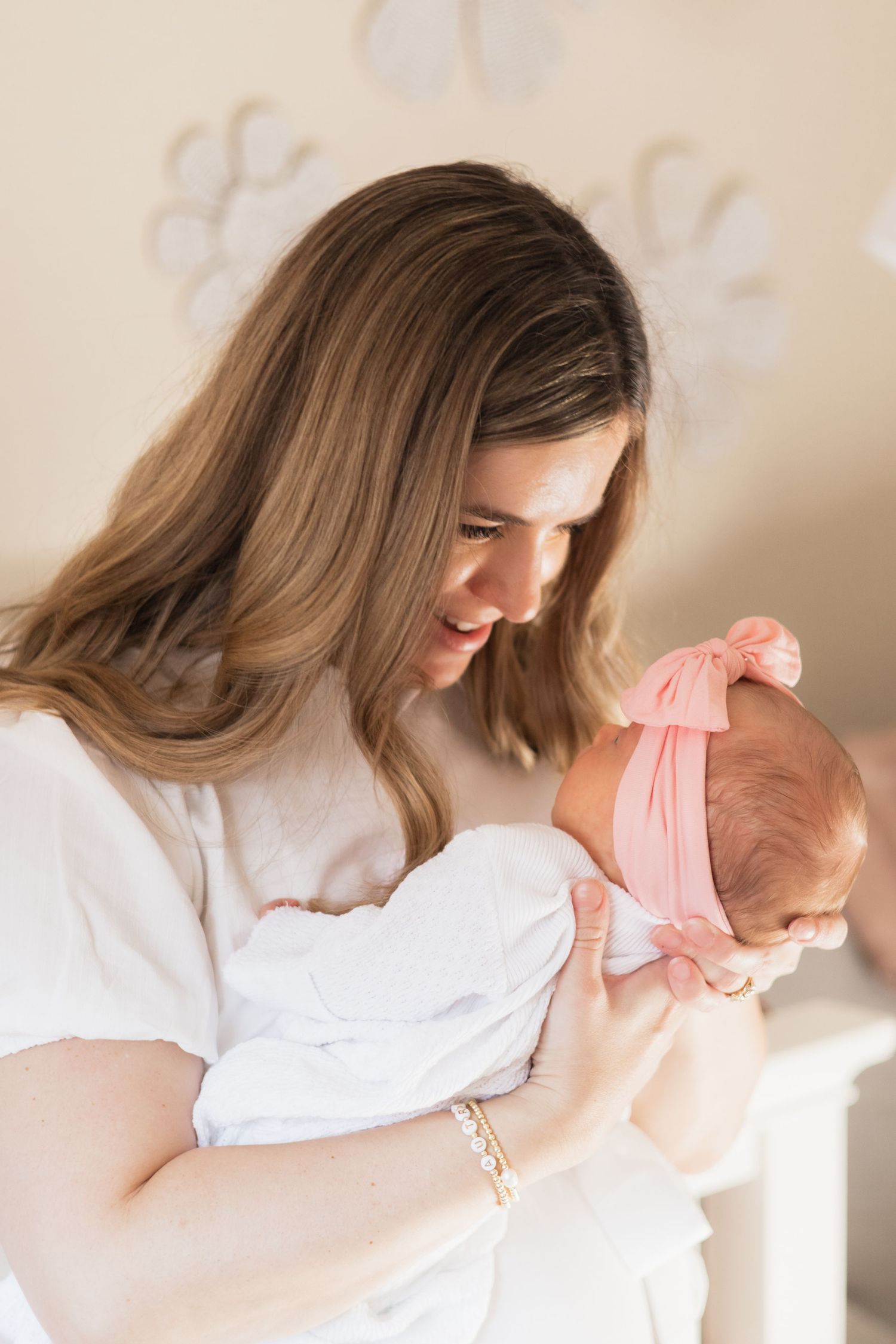 New Dallas mom smiles sweetly at newborn baby girl