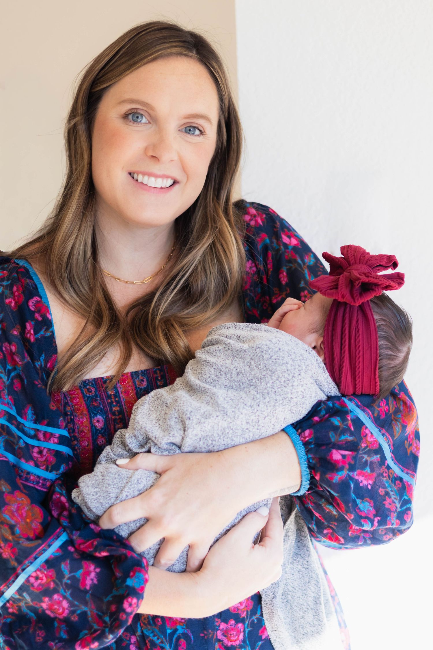 Dallas mom cradles baby during newborn photo shoot