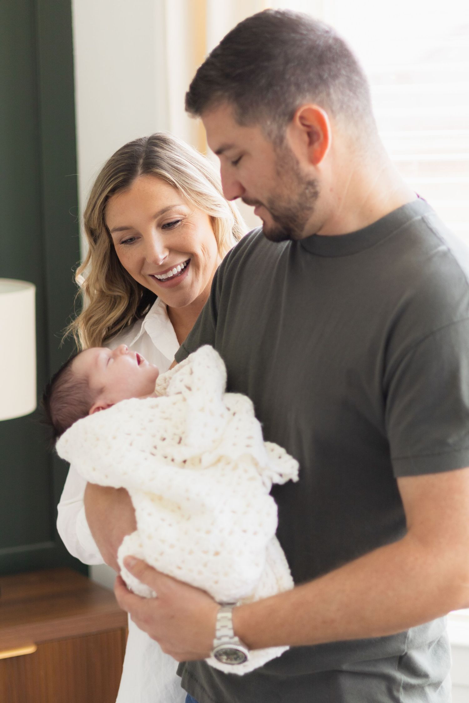 Dallas mom laughs as dad holds newborn son