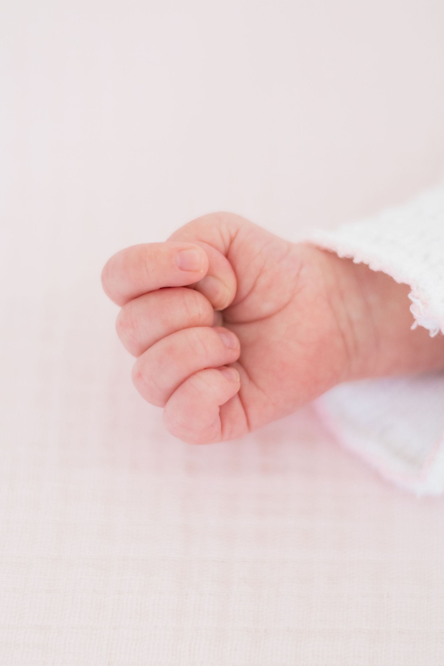 Newborn baby scrunched up hand during newborn photo shoot