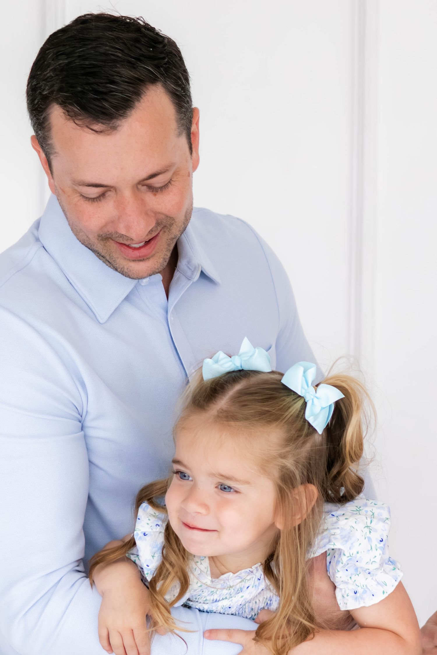 Dallas dad swings daughter playfully during a family photoshoot