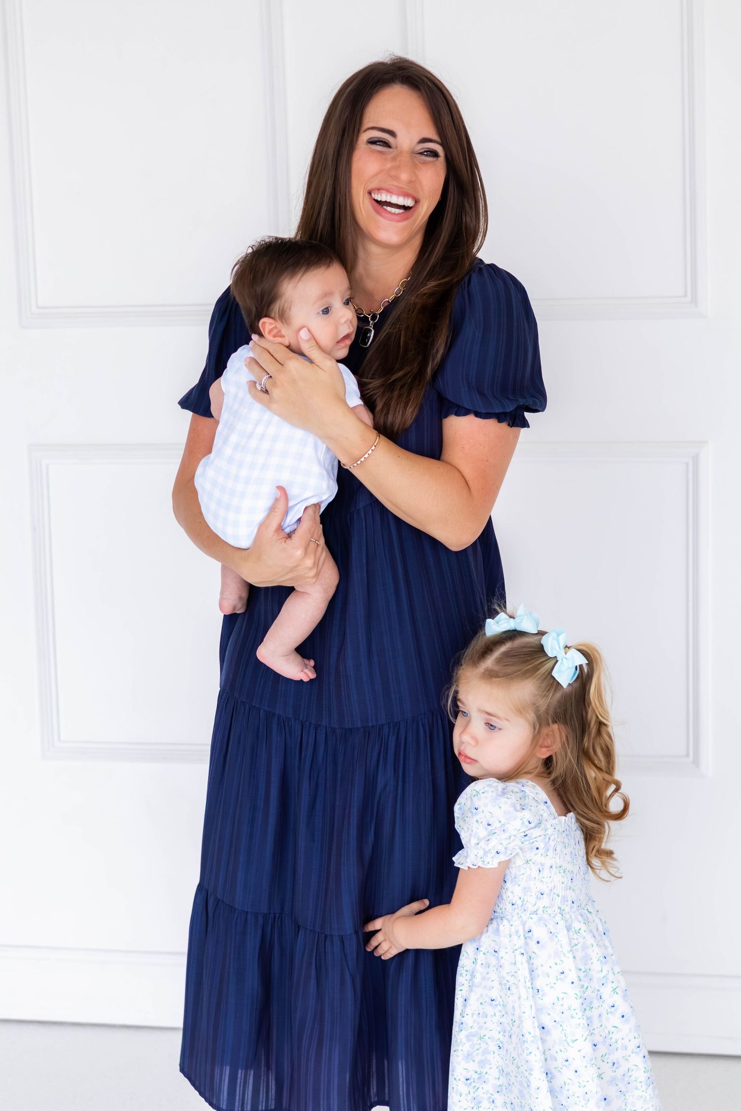 Mom of two smiles at the camera during a DFW family photo session
