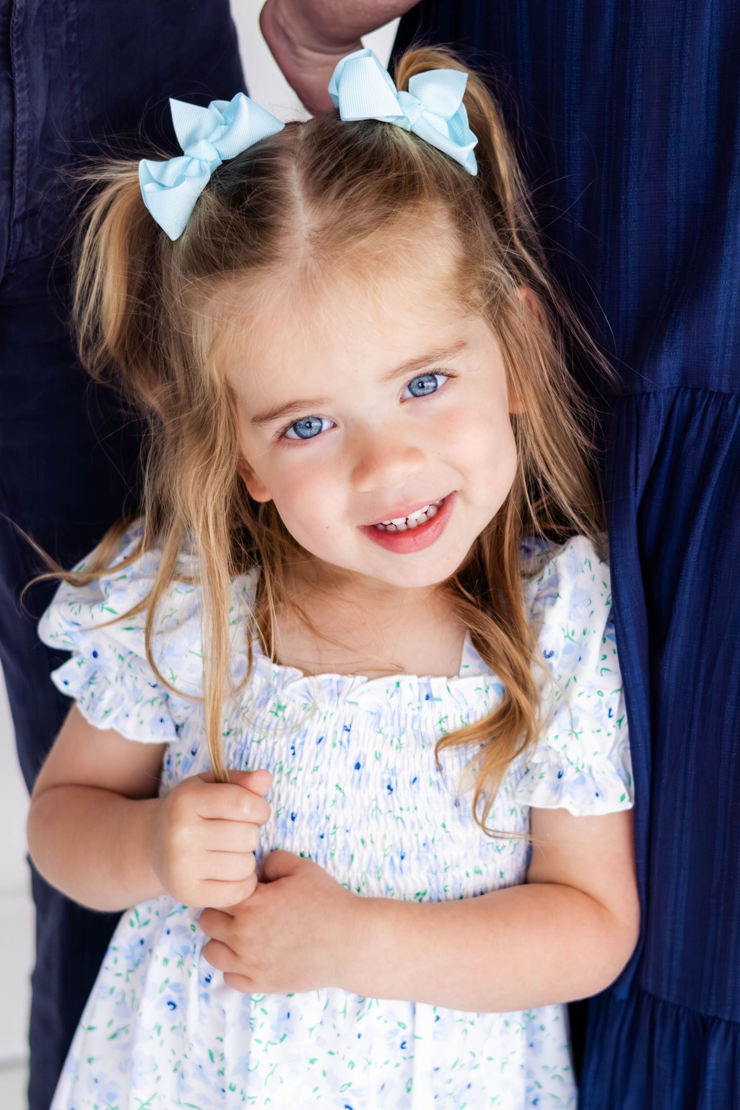 Toddler smiling at camera during a DFW family studio session