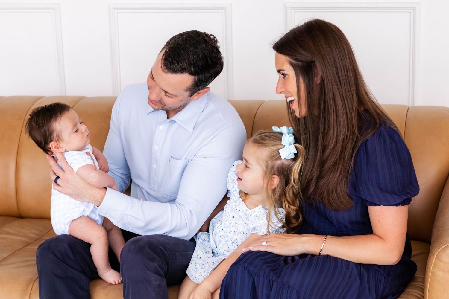 Dallas family snuggles together on a couch during family photos