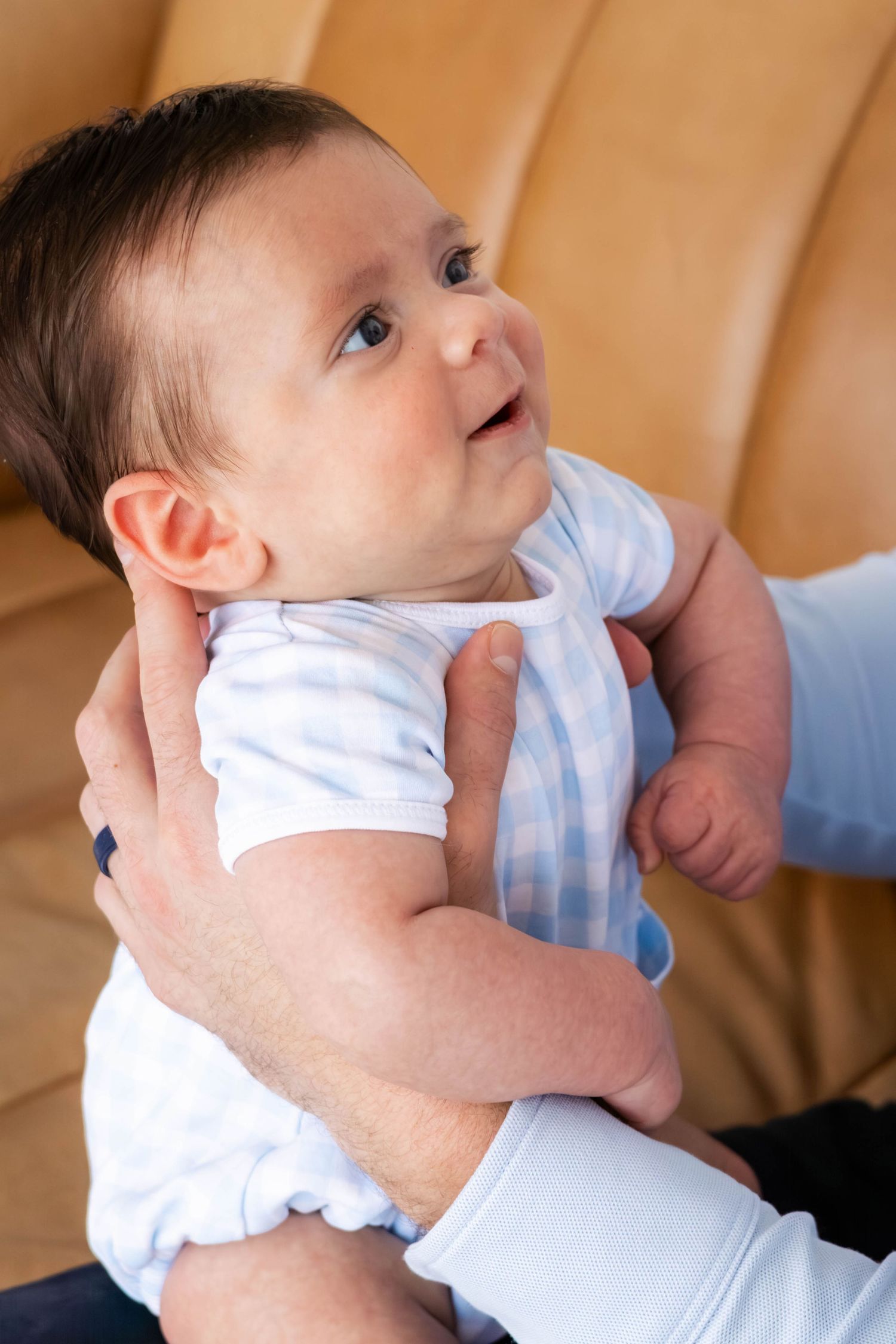 Close up of baby boy smiling at his dad