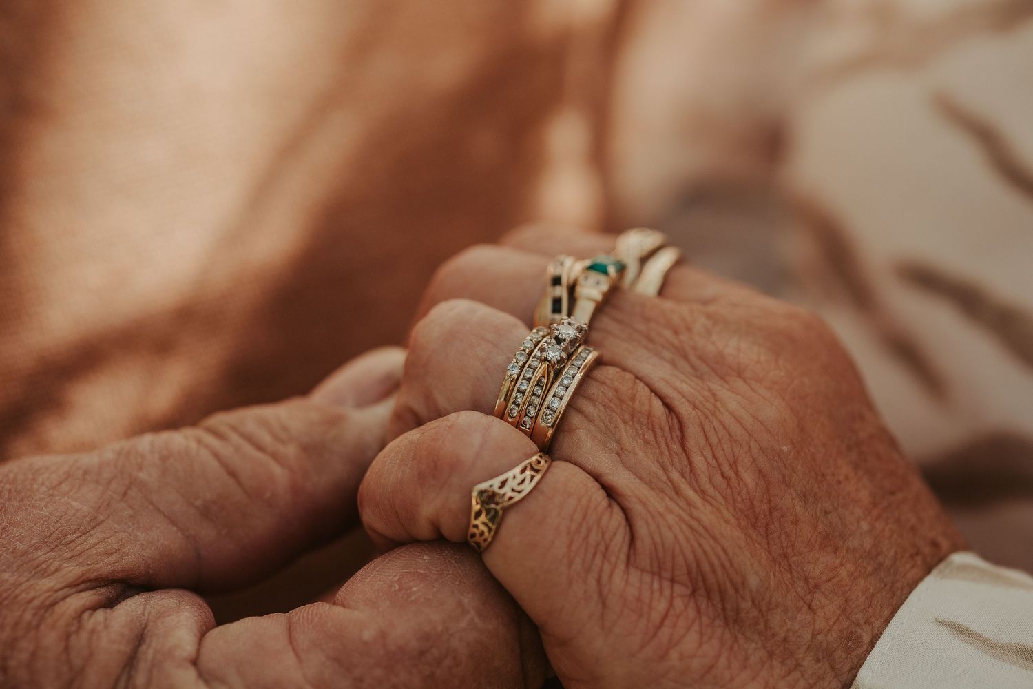 Close-up shots of hands wearing wedding rings in sequence.