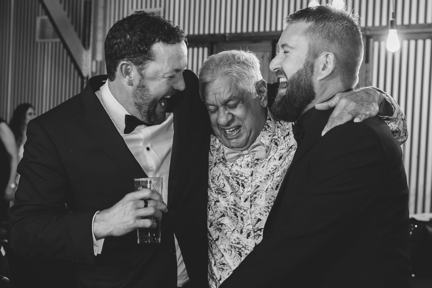Candid moments of guests socializing and laughing at formal evening event.