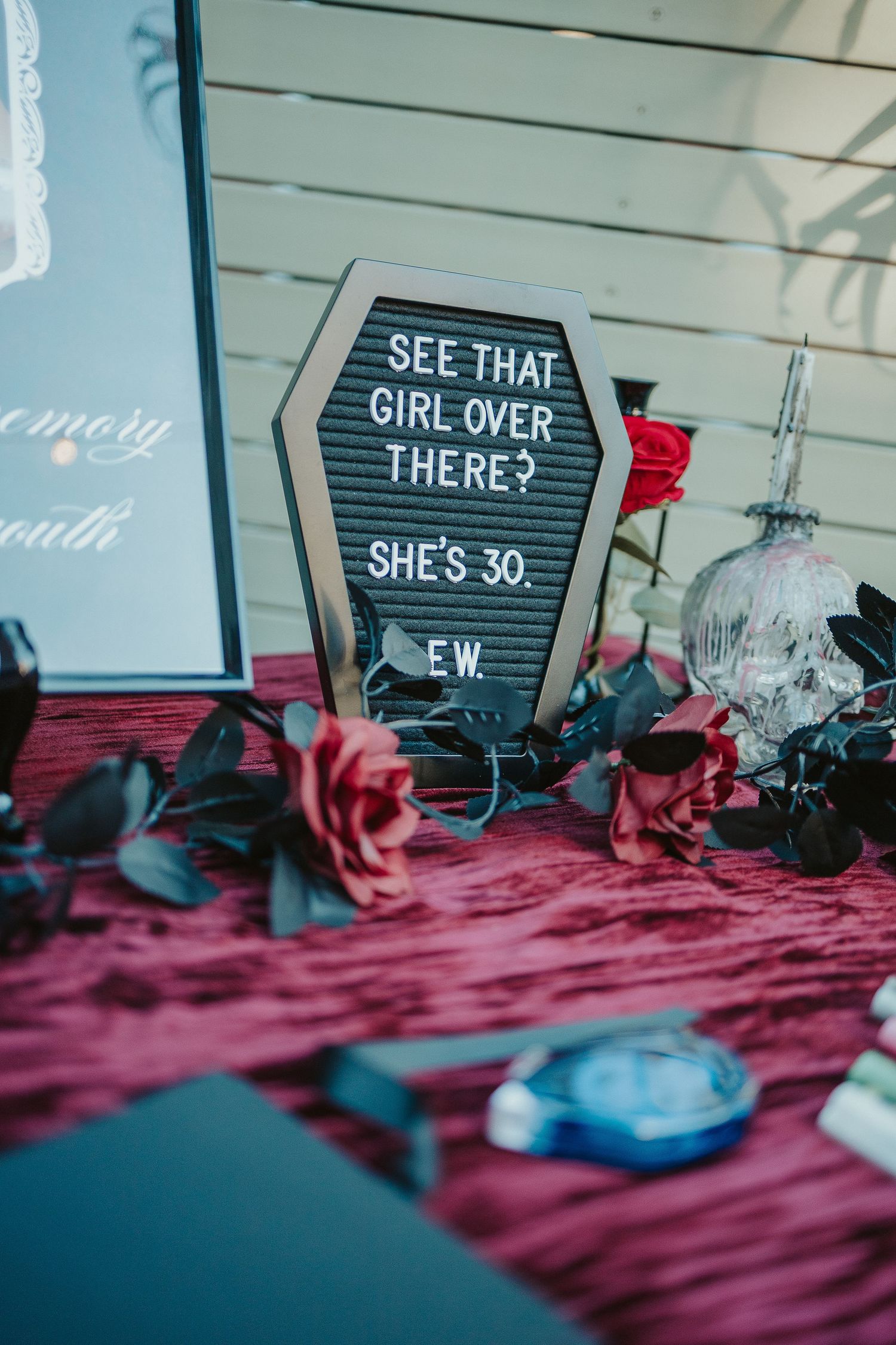 Letter board signs with text displayed against pink and blue decorative background.