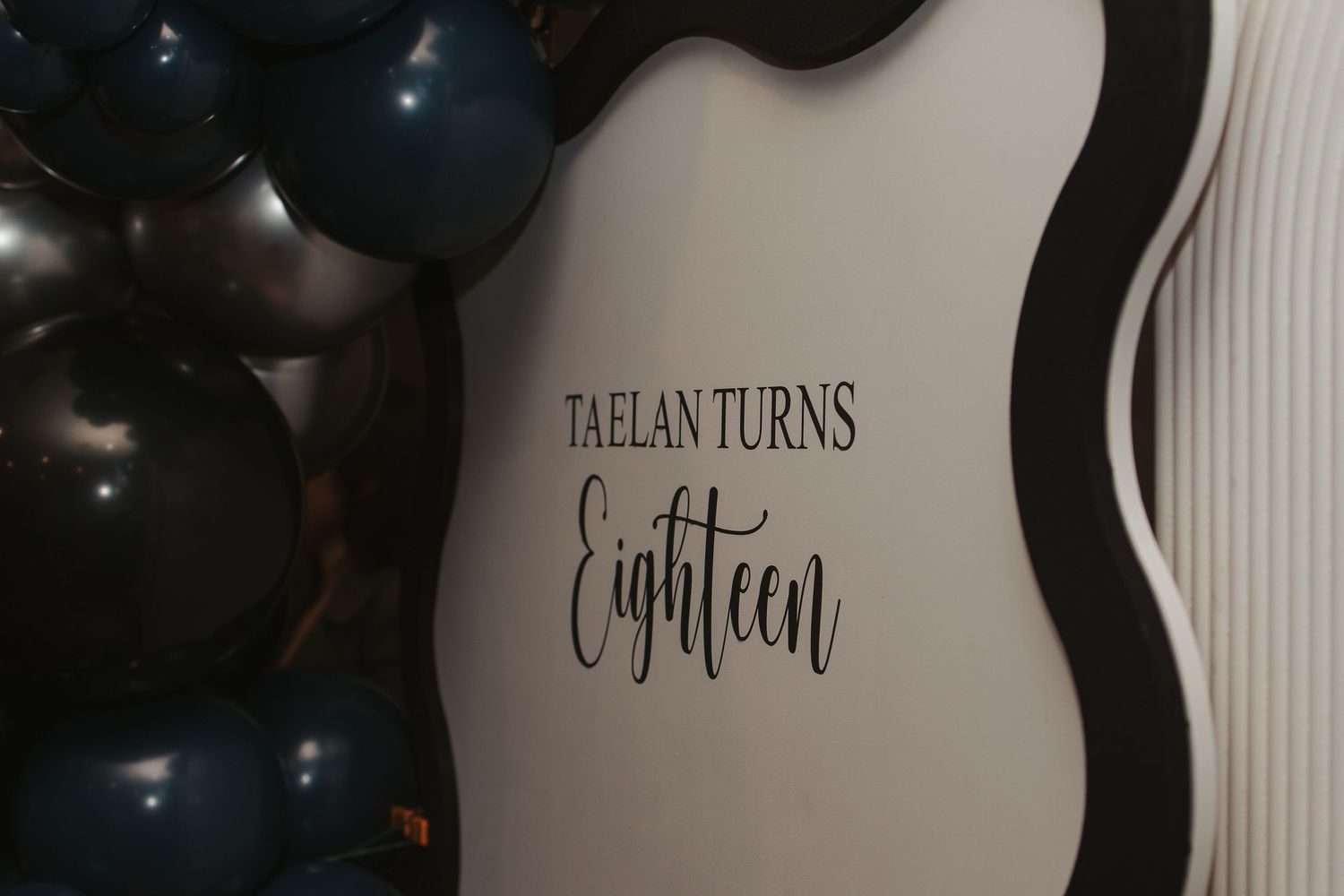 Black and white text designs displayed on a wall in an elegant typography arrangement.
