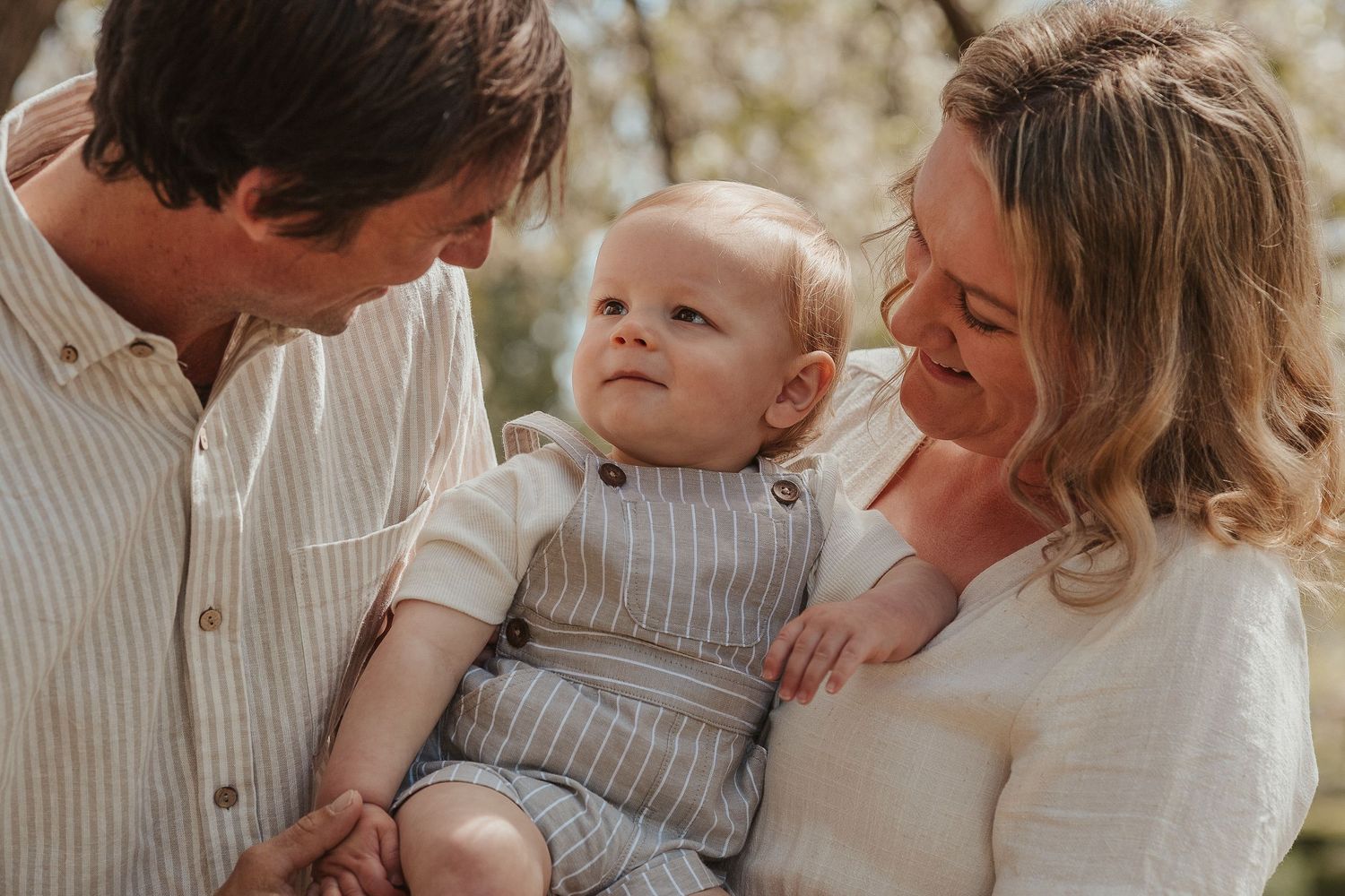 Intimate family portrait session with soft natural lighting and neutral tones.
