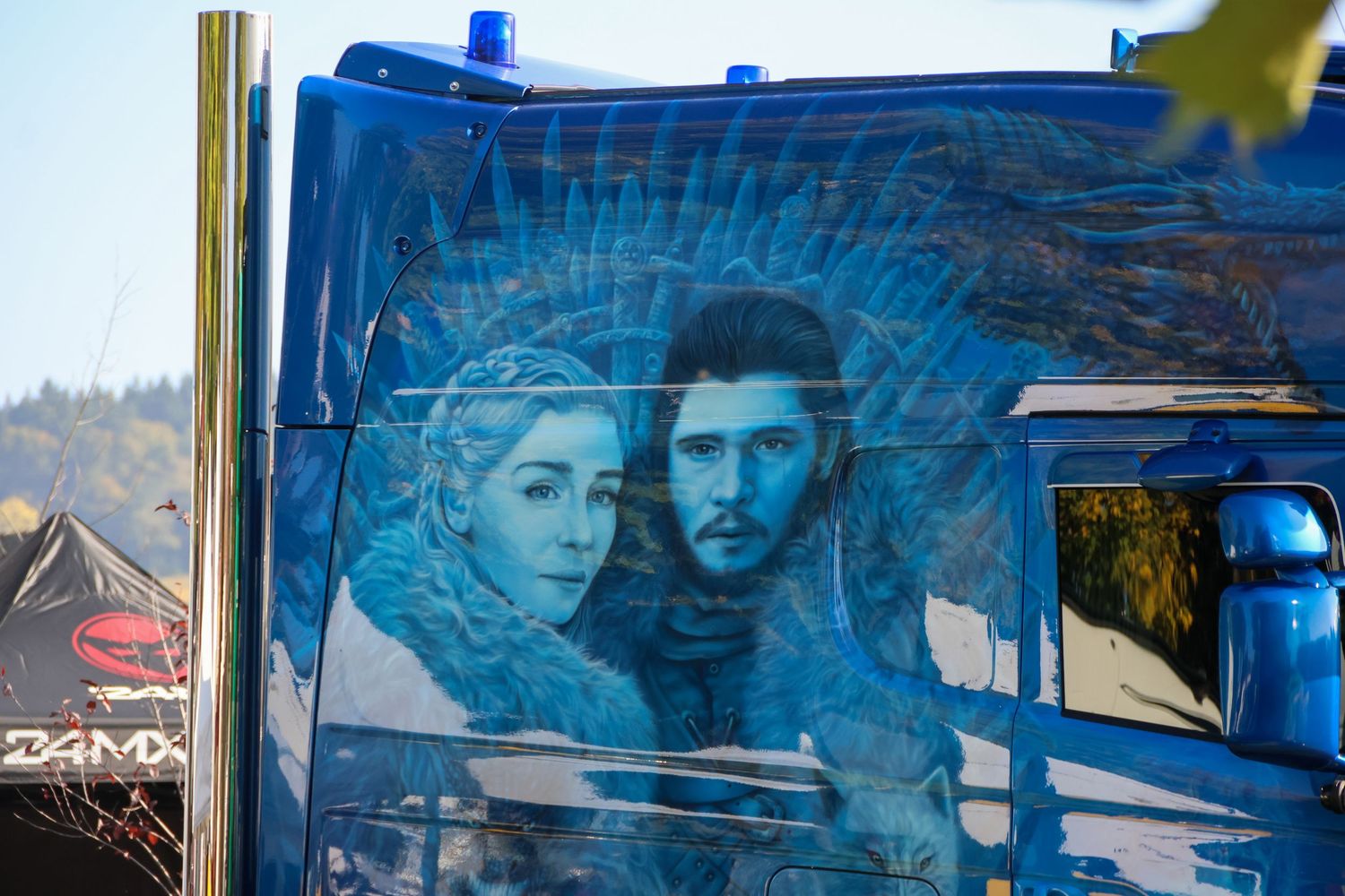 Artistic airbrush painting of two Game of Thrones characters on the side of a blue truck cab.