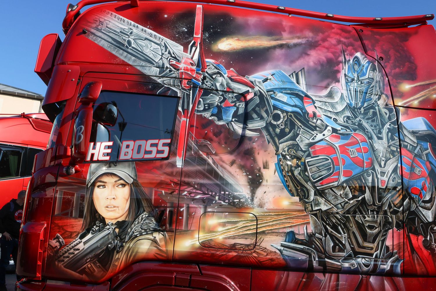 Red truck cab with dramatic Transformers Optimus Prime and female figure airbrush mural labeled The Boss.