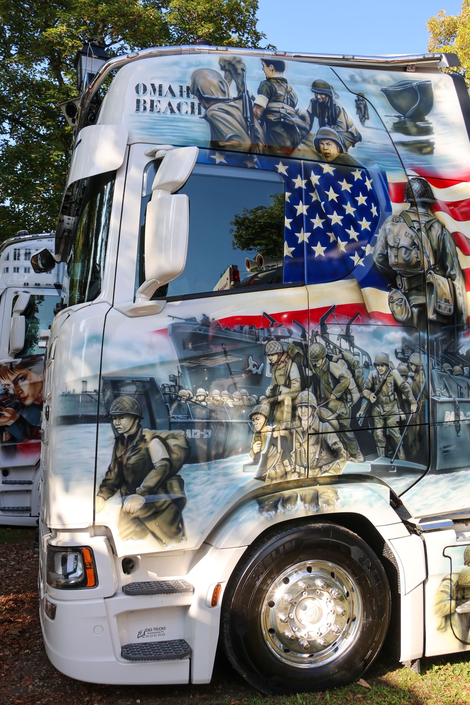 Custom painted truck cab featuring WWII D-Day Omaha Beach soldiers and American flag artwork.