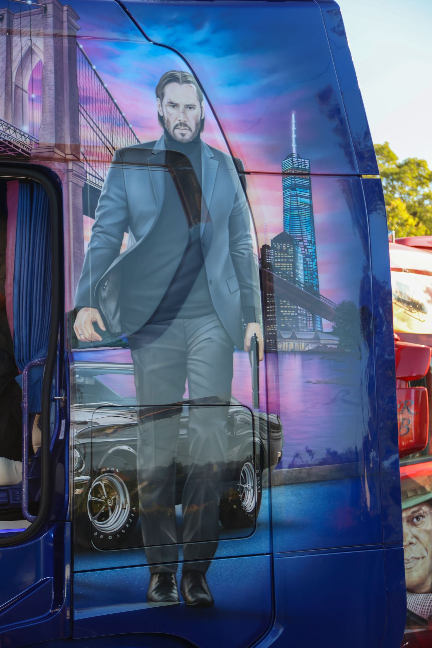 Blue truck door featuring a John Wick inspired airbrush mural with Brooklyn Bridge and NYC skyline.