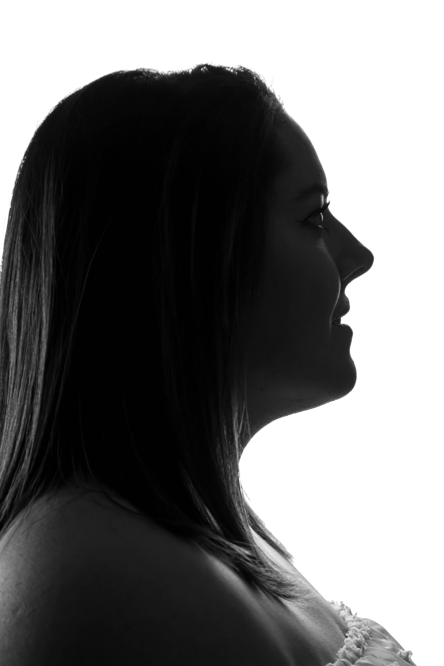 Séance Harmonie — portrait studio noir et blanc silhouette dramatique de profil jeune femme aux longs cheveux lisses, photographe marne