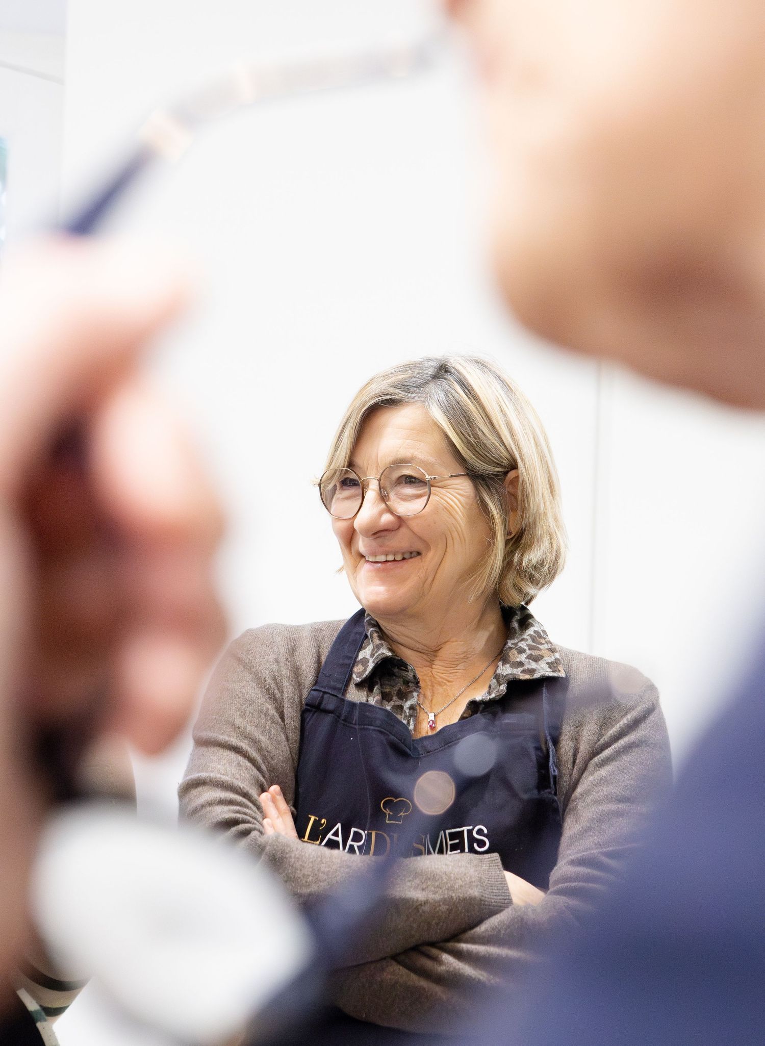 Personne souriante engagée dans une conversation lors d'un rassemblement.